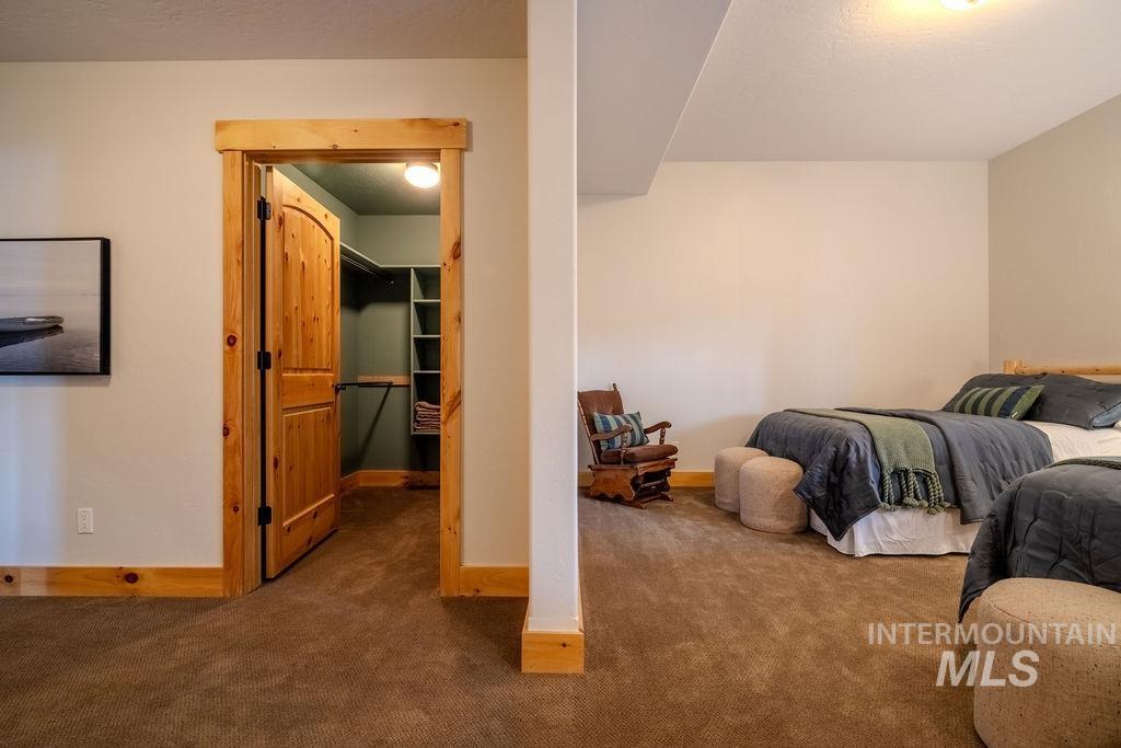 Spacious interior featuring neutral wall tones and plush carpeting
