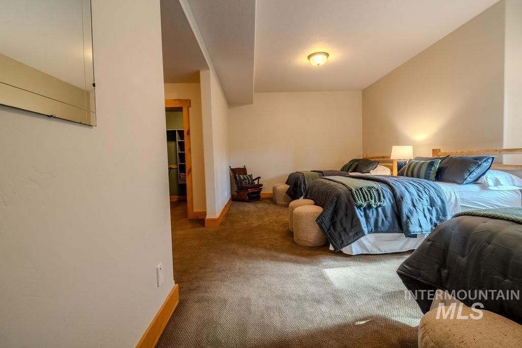 Carpeted room with light neutral walls and wood trim