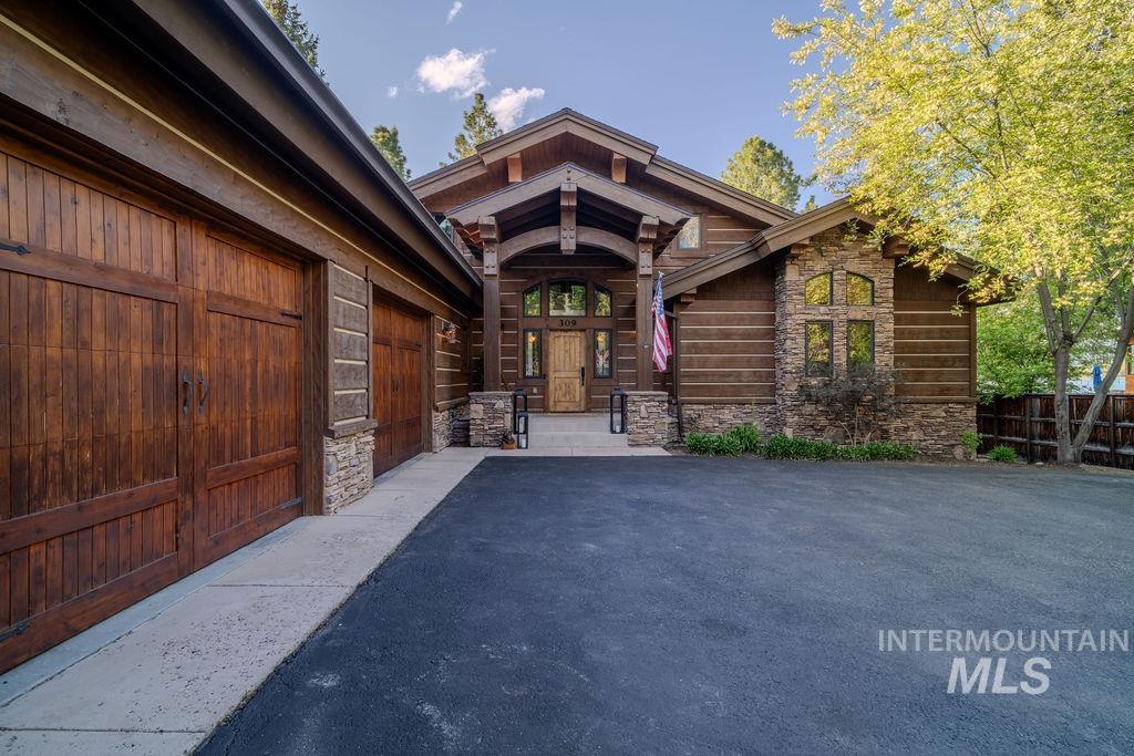 Craftsman-style facade featuring horizontal wood siding and stone accents