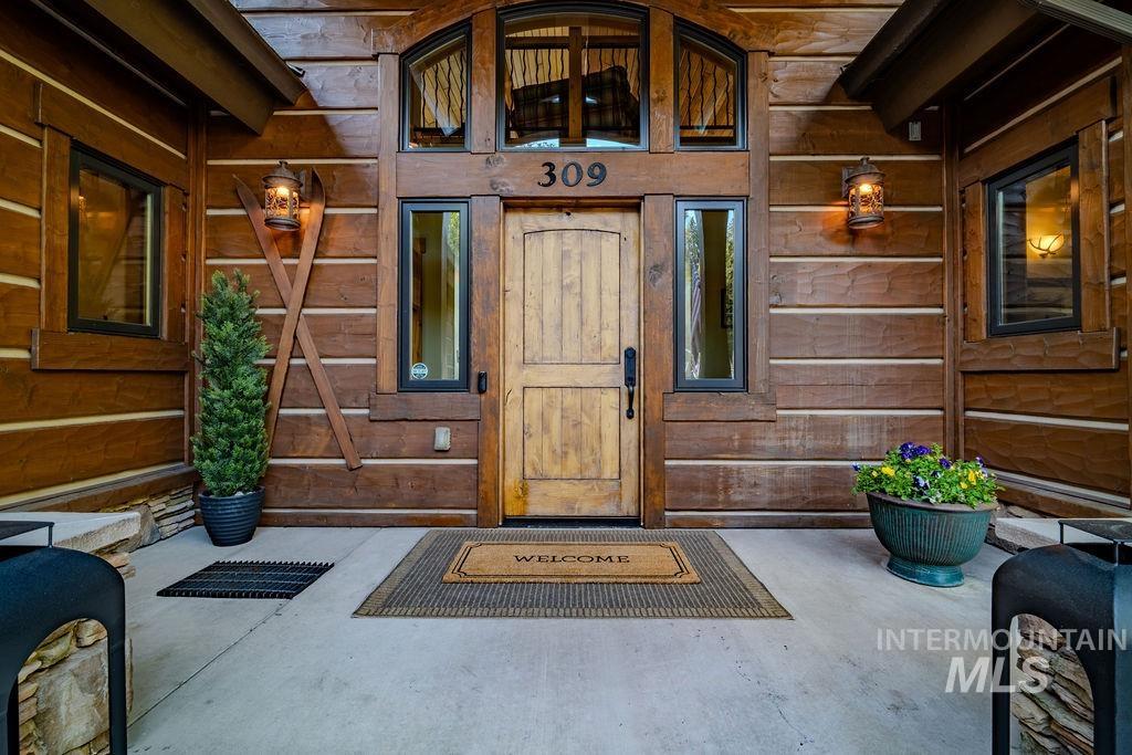 Rustic wood-clad exterior with a solid wood entry door