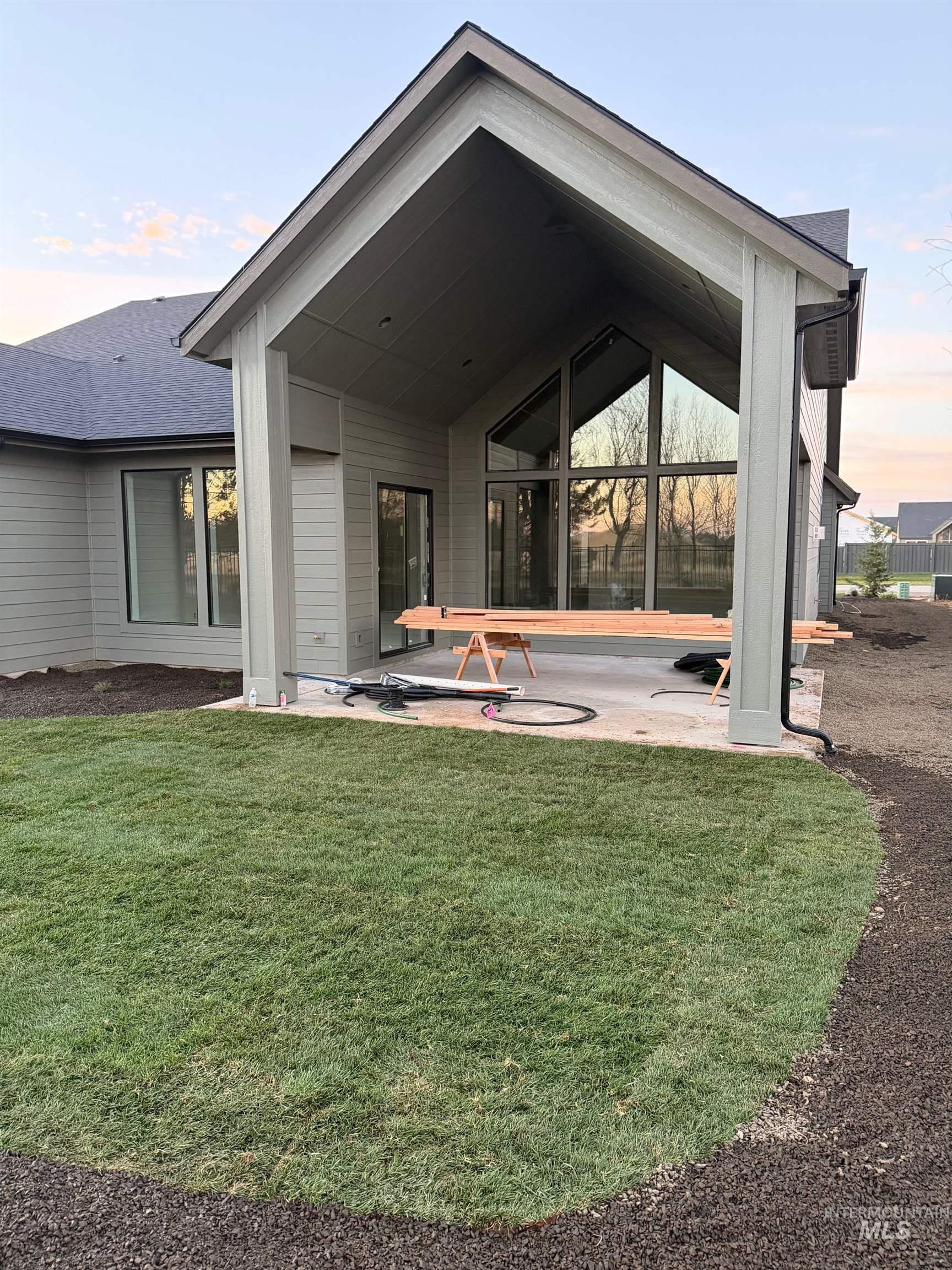 Rear view of property featuring a patio and a lawn