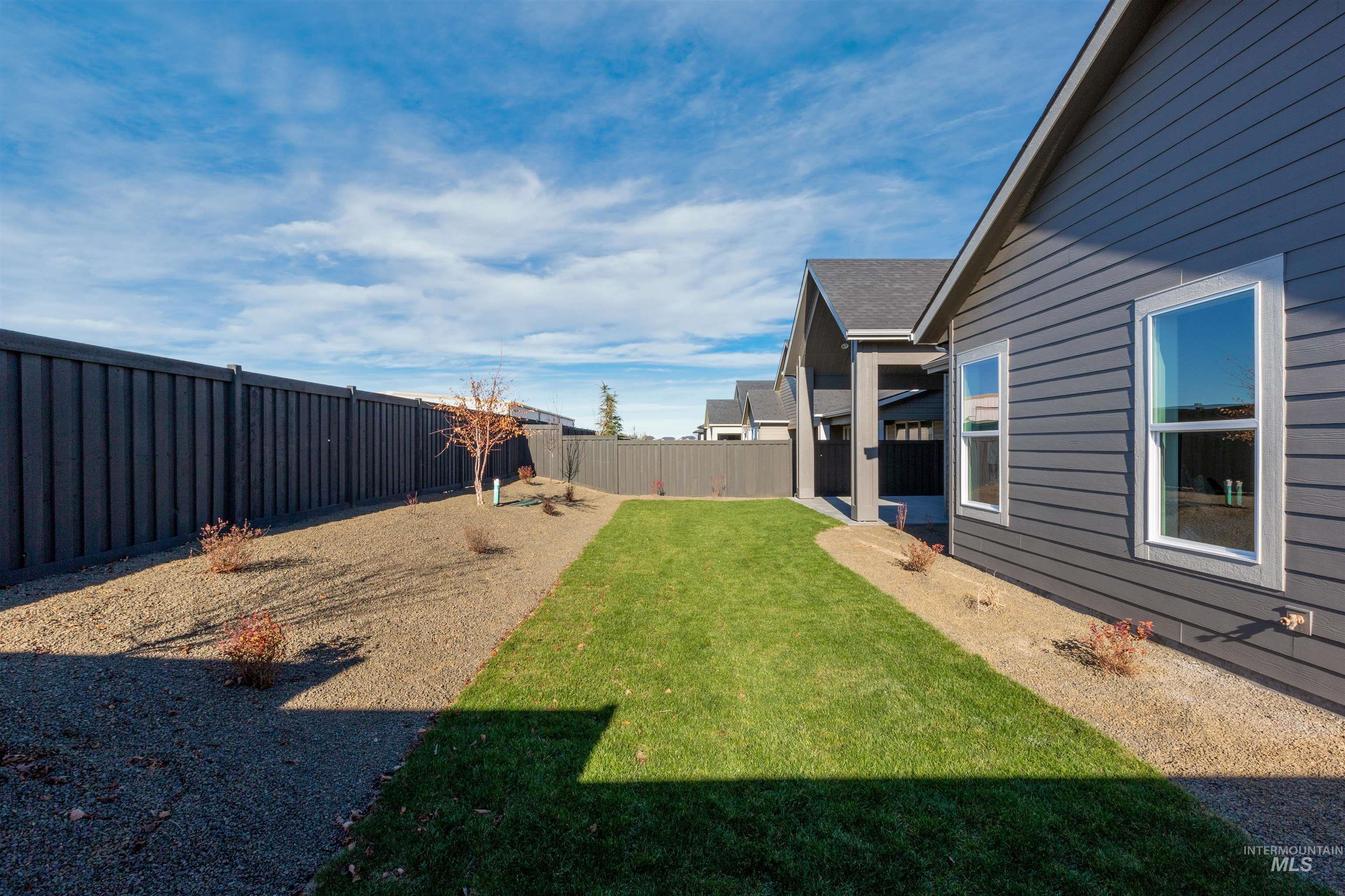 Fenced backyard with a patio area