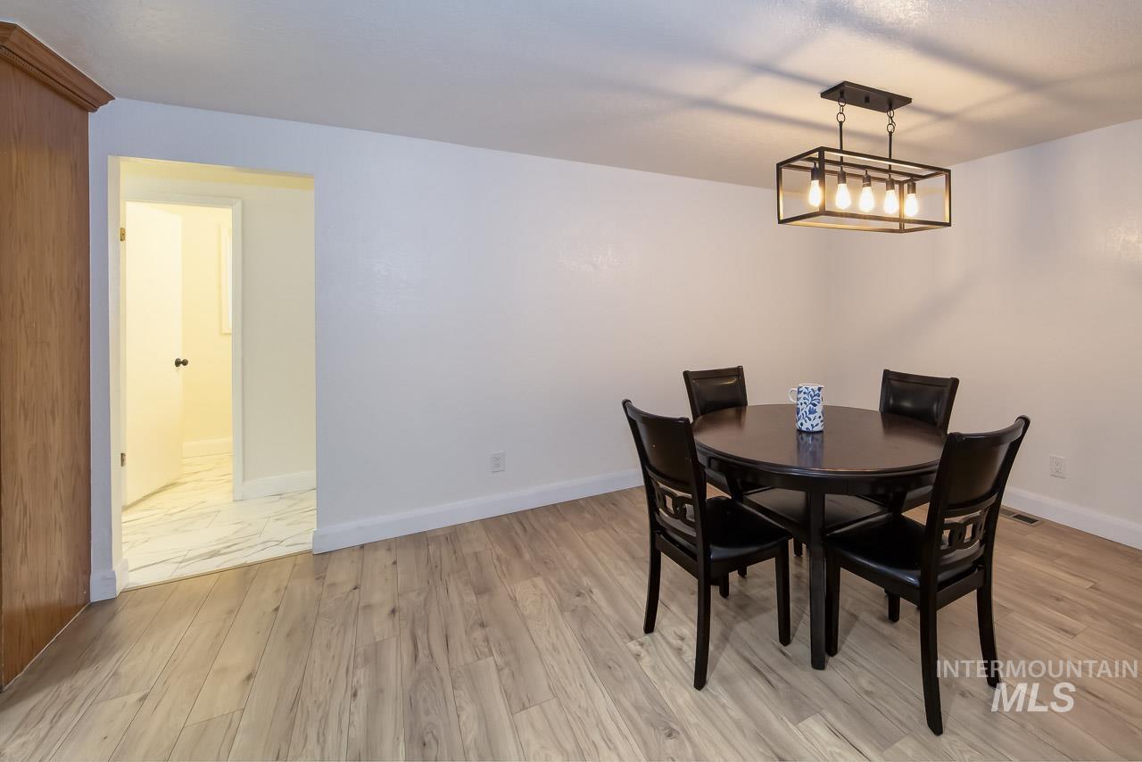 Dining room featuring light wood-style floors and baseboards