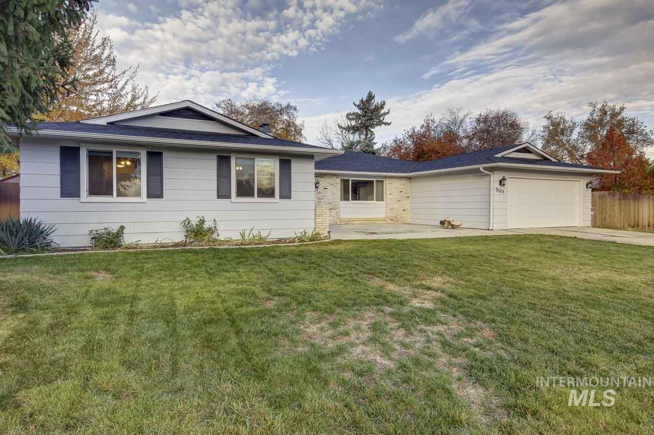 Ranch-style home with an attached garage, concrete driveway, and a patio