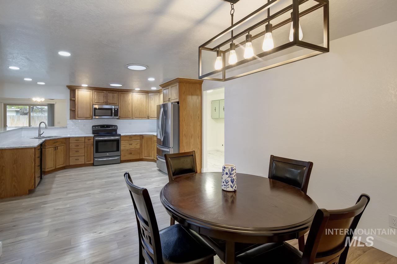 Dining room featuring light wood-style flooring and recessed lighting