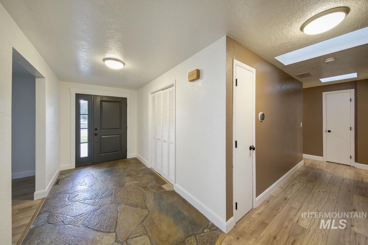 Foyer entrance featuring a textured ceiling and light wood-style flooring