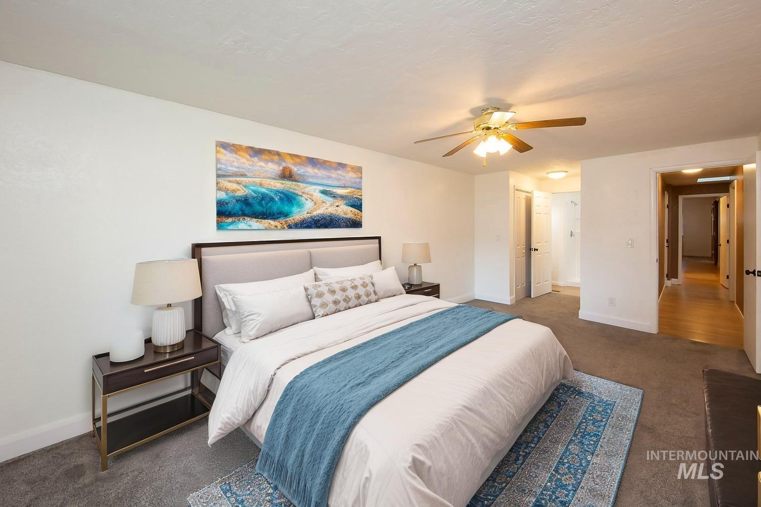 Carpeted bedroom featuring baseboards and ceiling fan