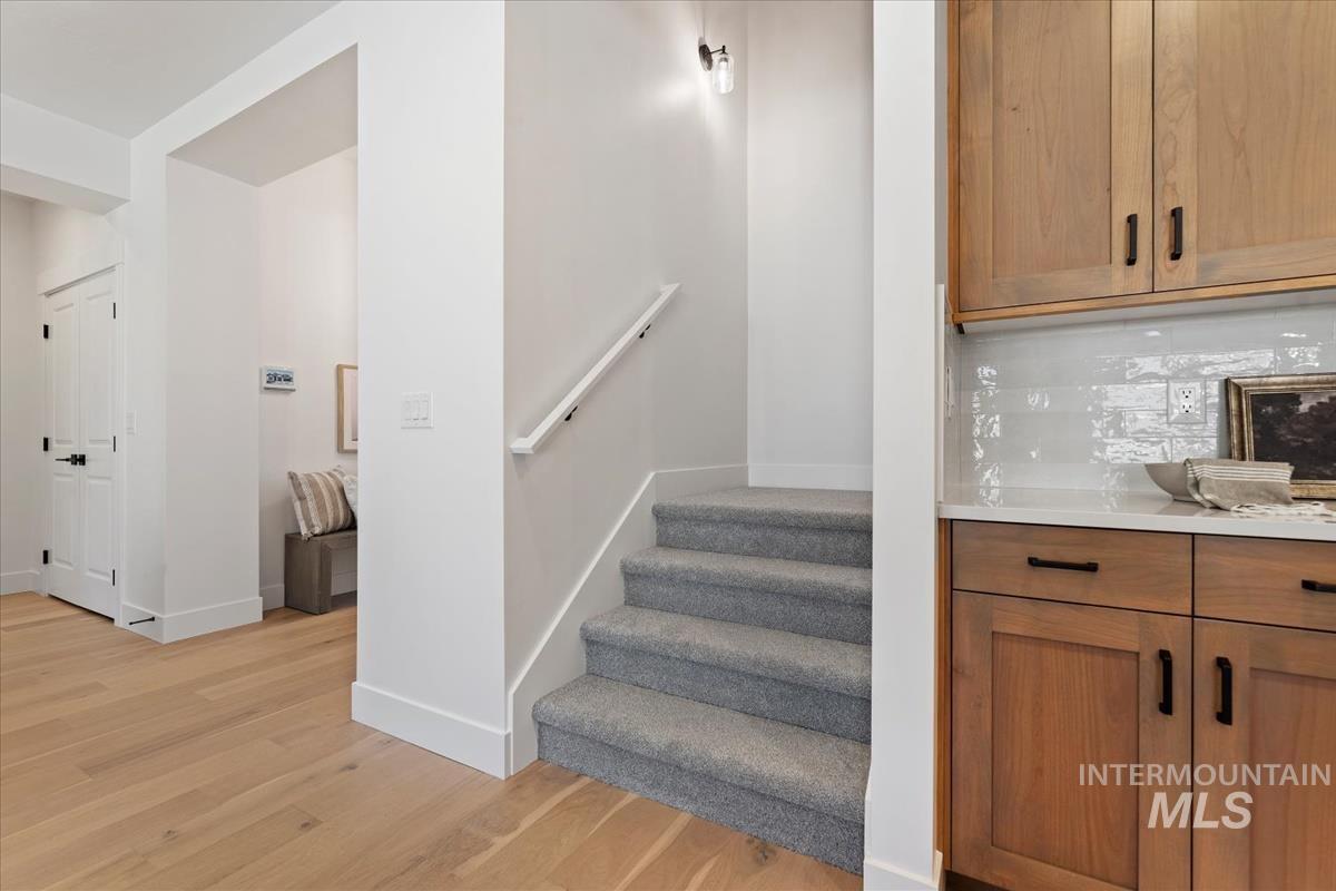 Stairway featuring wood finished floors and baseboards