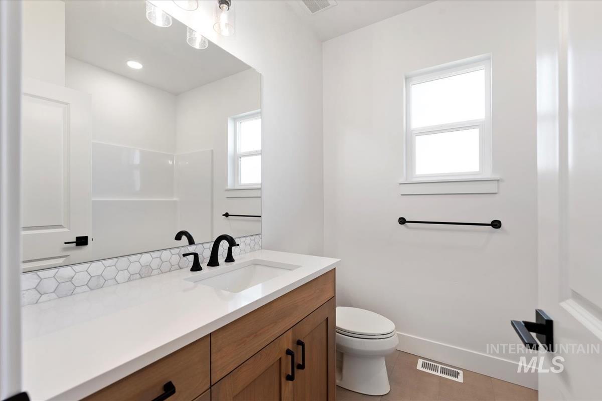 Full bathroom featuring vanity, light tile patterned flooring, and recessed lighting