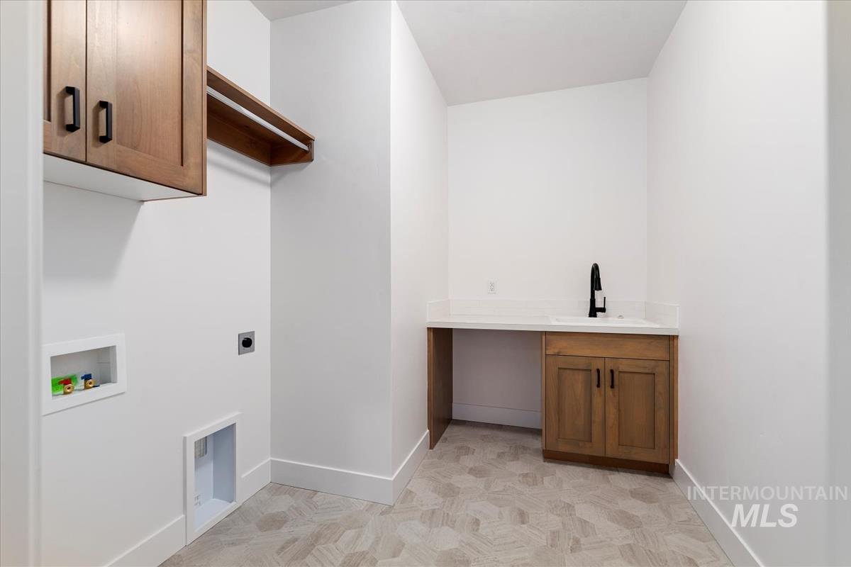 Laundry room featuring cabinet space, hookup for a washing machine, and electric dryer hookup