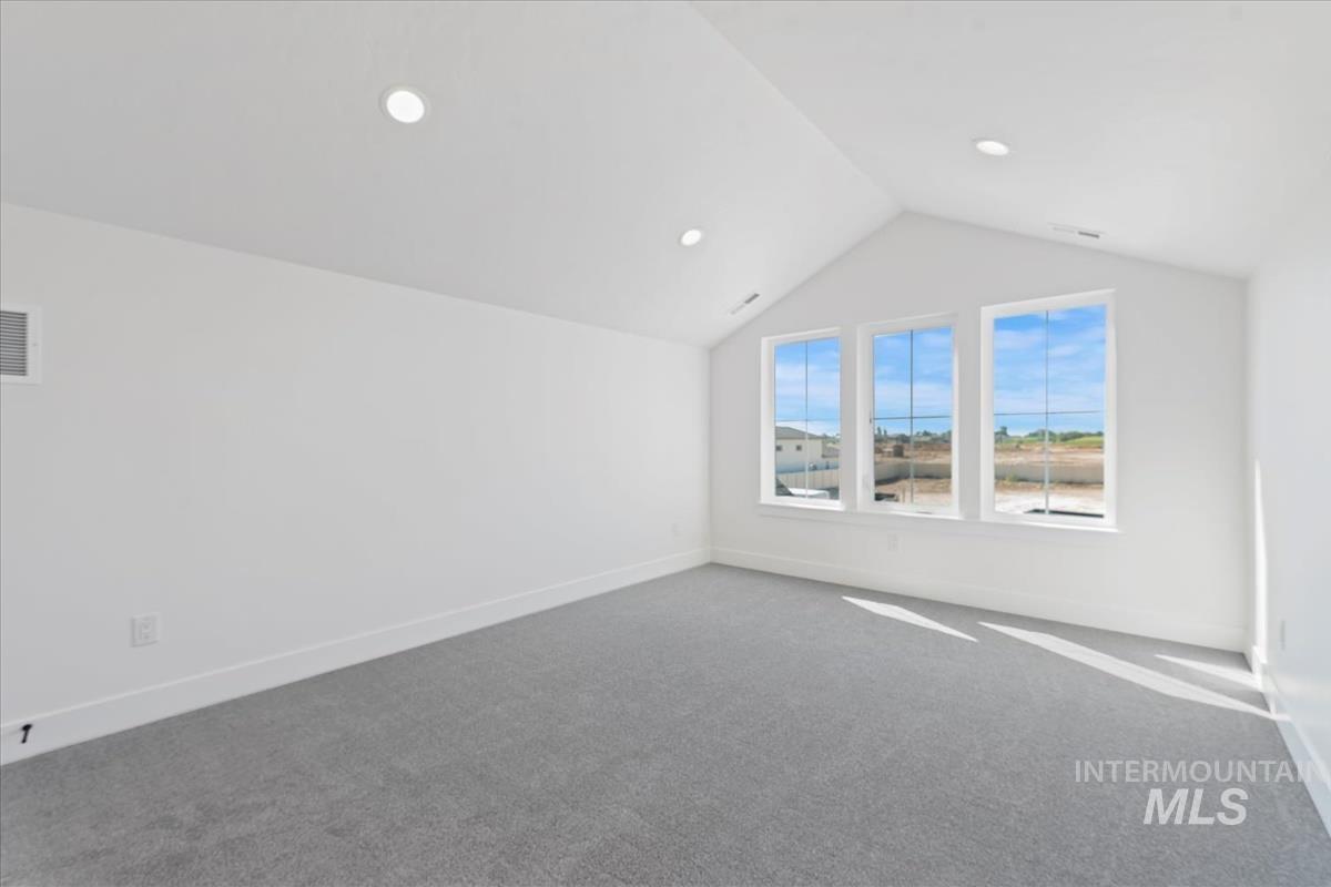 Additional living space featuring carpet flooring, lofted ceiling, and recessed lighting