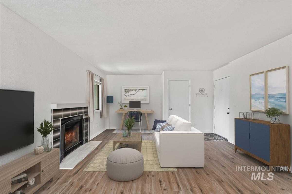 Living area featuring light wood finished floors and a fireplace