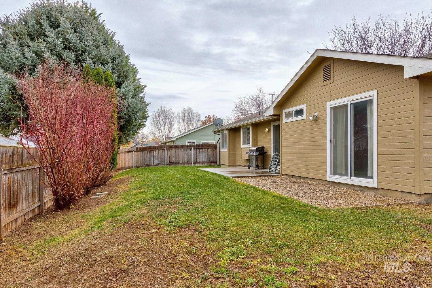 Fenced backyard with a patio area