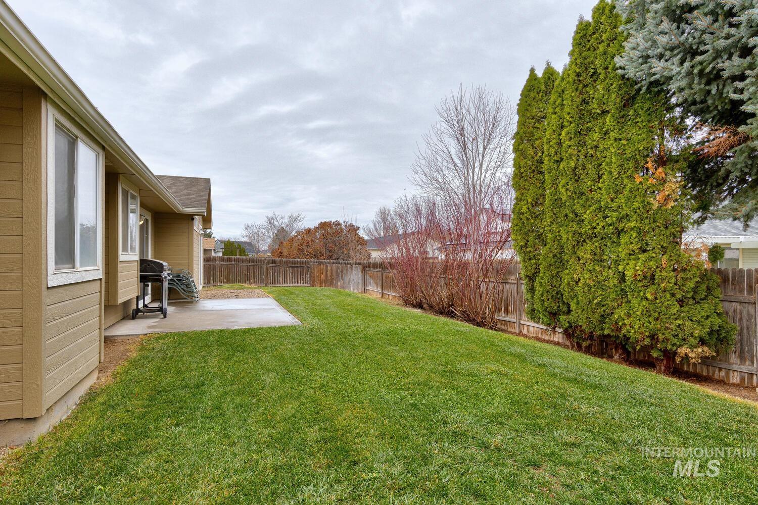Fenced backyard with a patio area