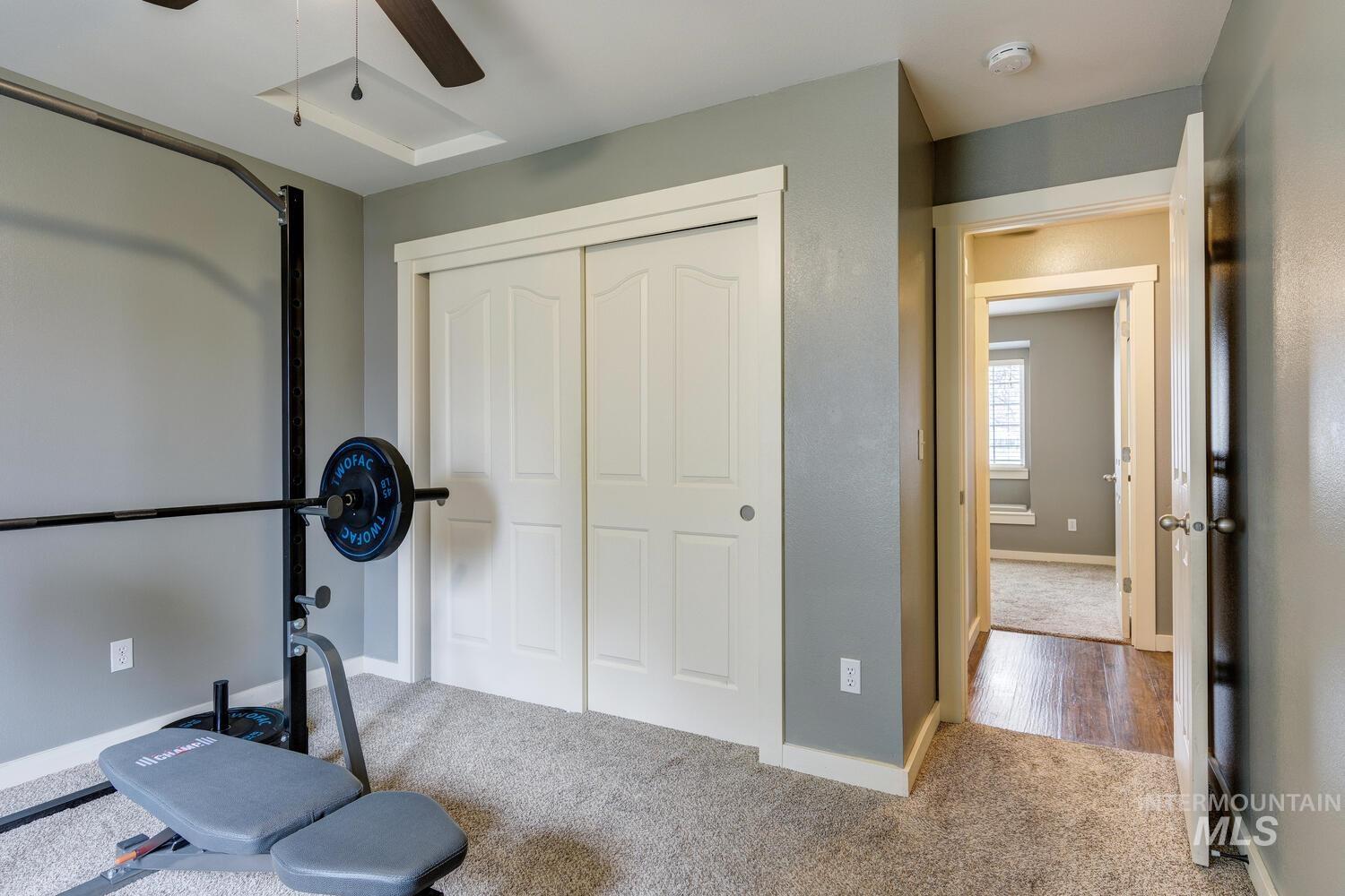 Workout room featuring carpet flooring and ceiling fan
