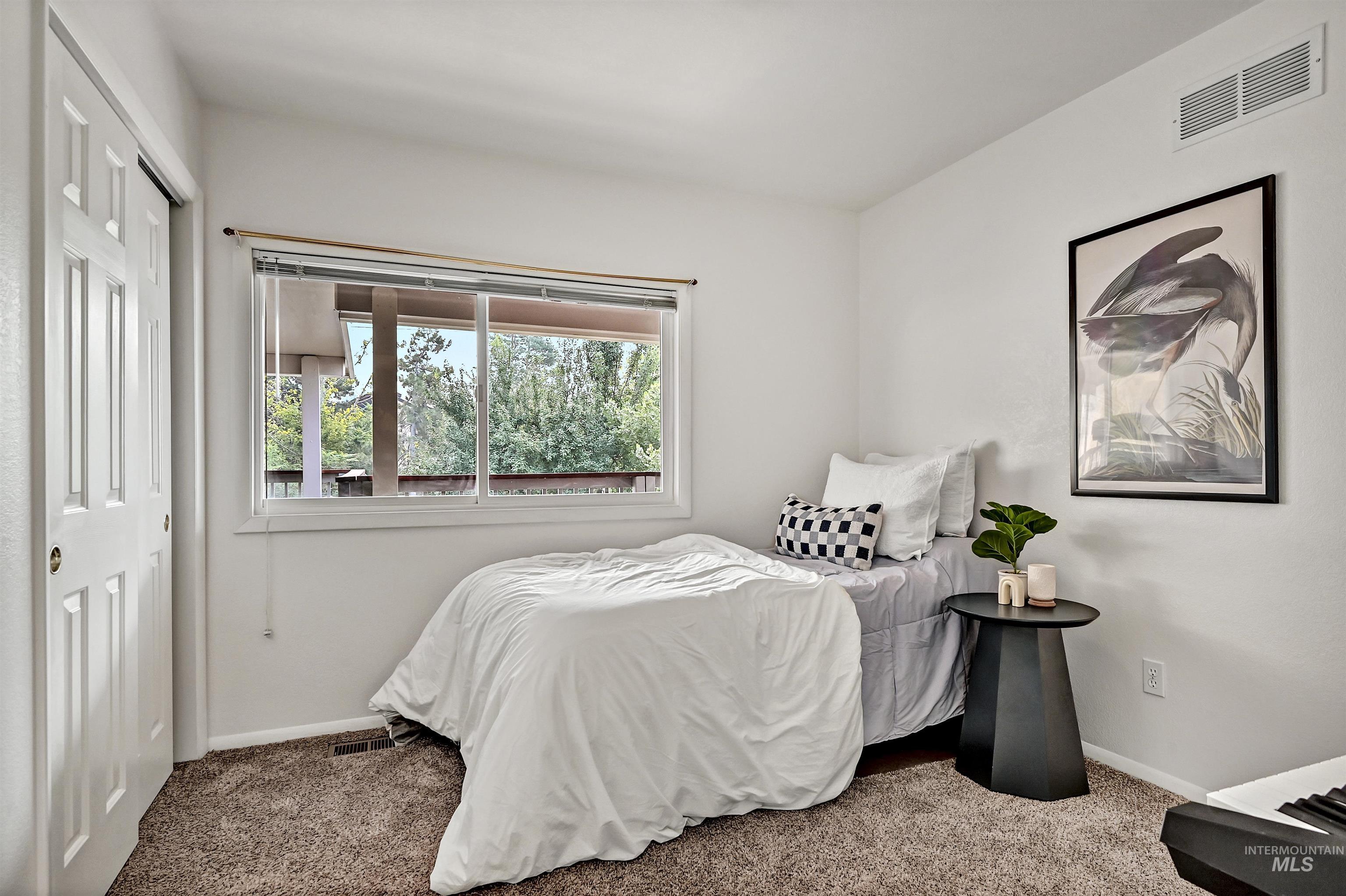 Bedroom with carpet floors and a closet
