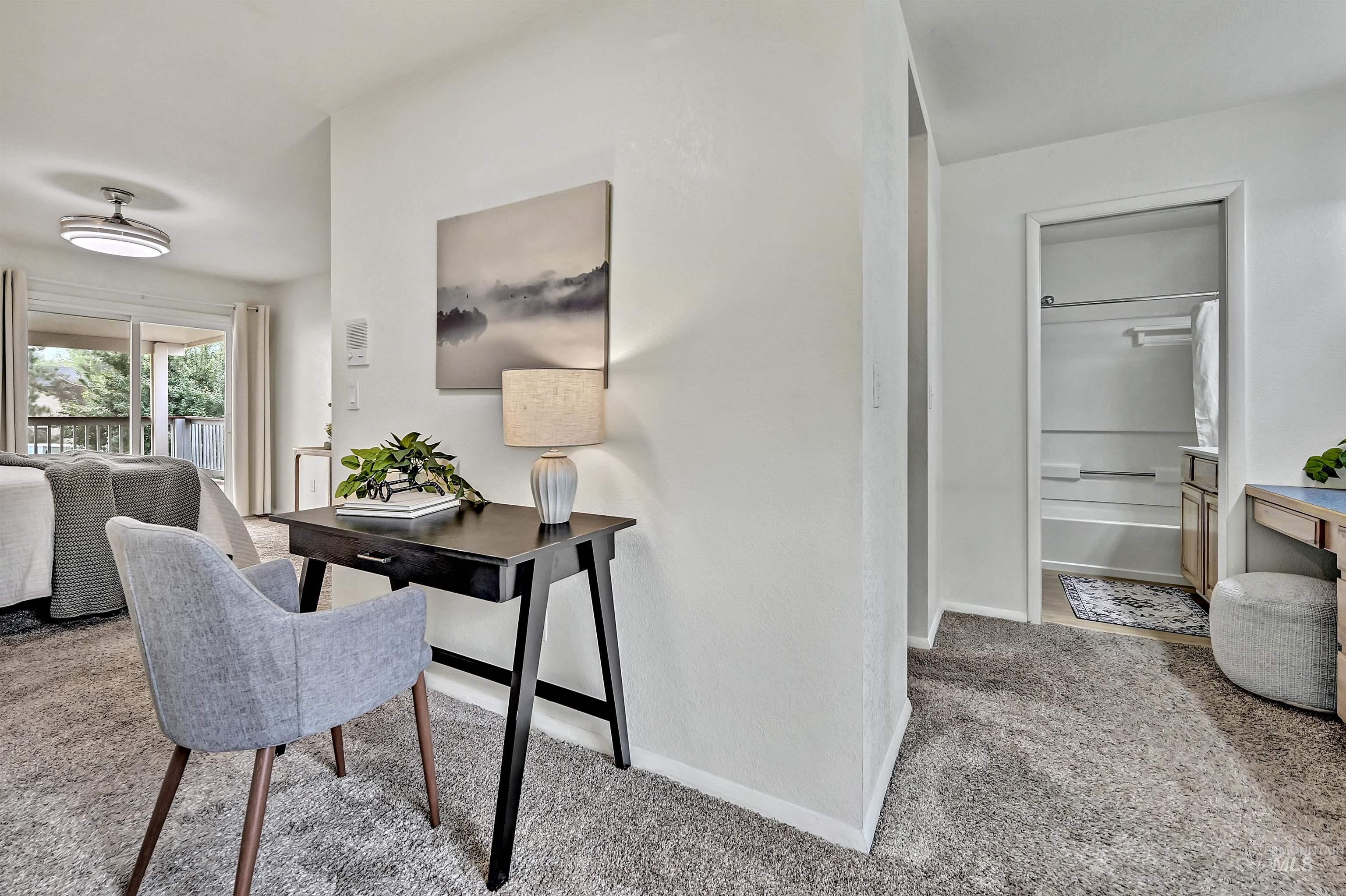 Office area with light colored carpet and baseboards