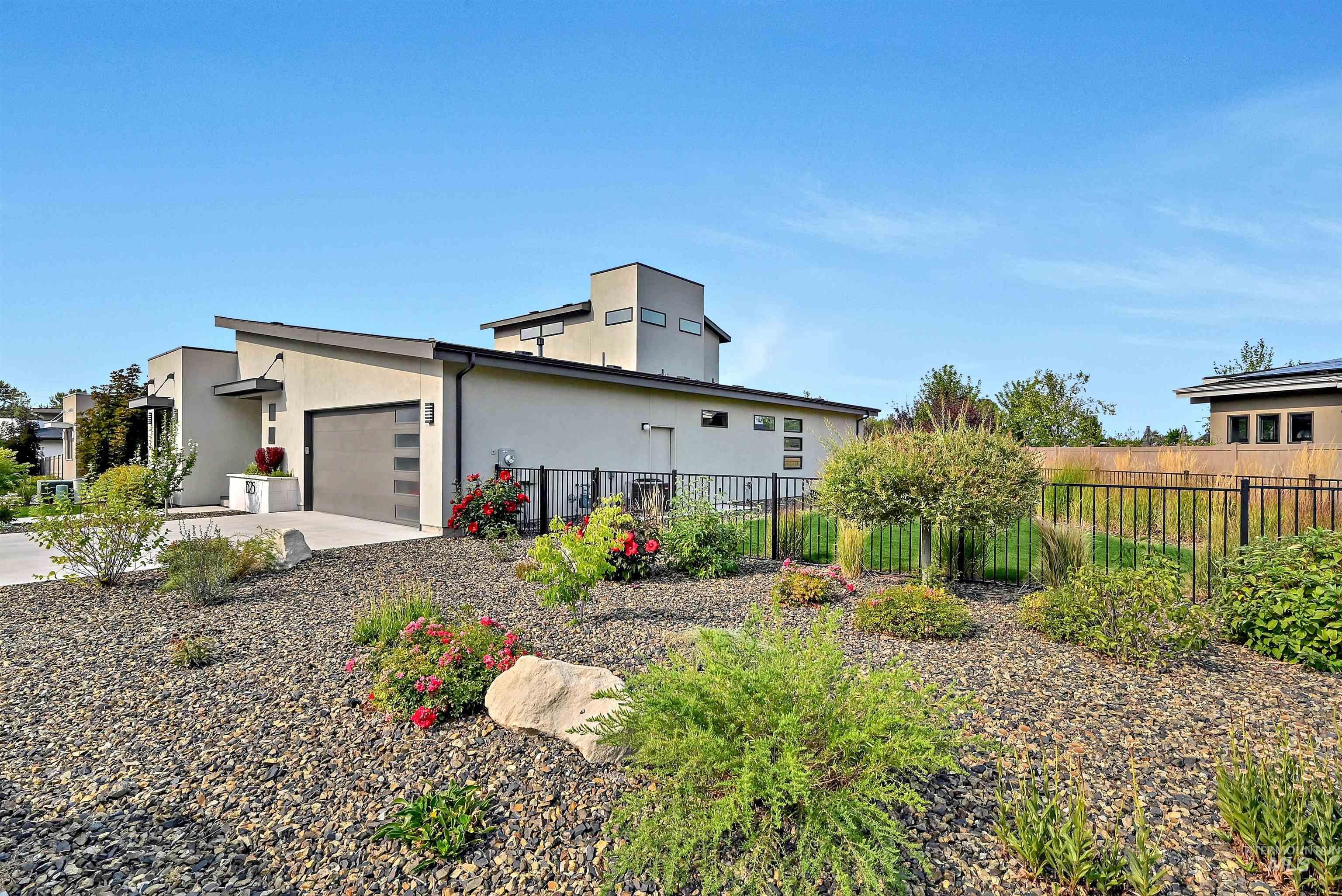 View of side of home featuring a garage, stucco siding, and concrete driveway