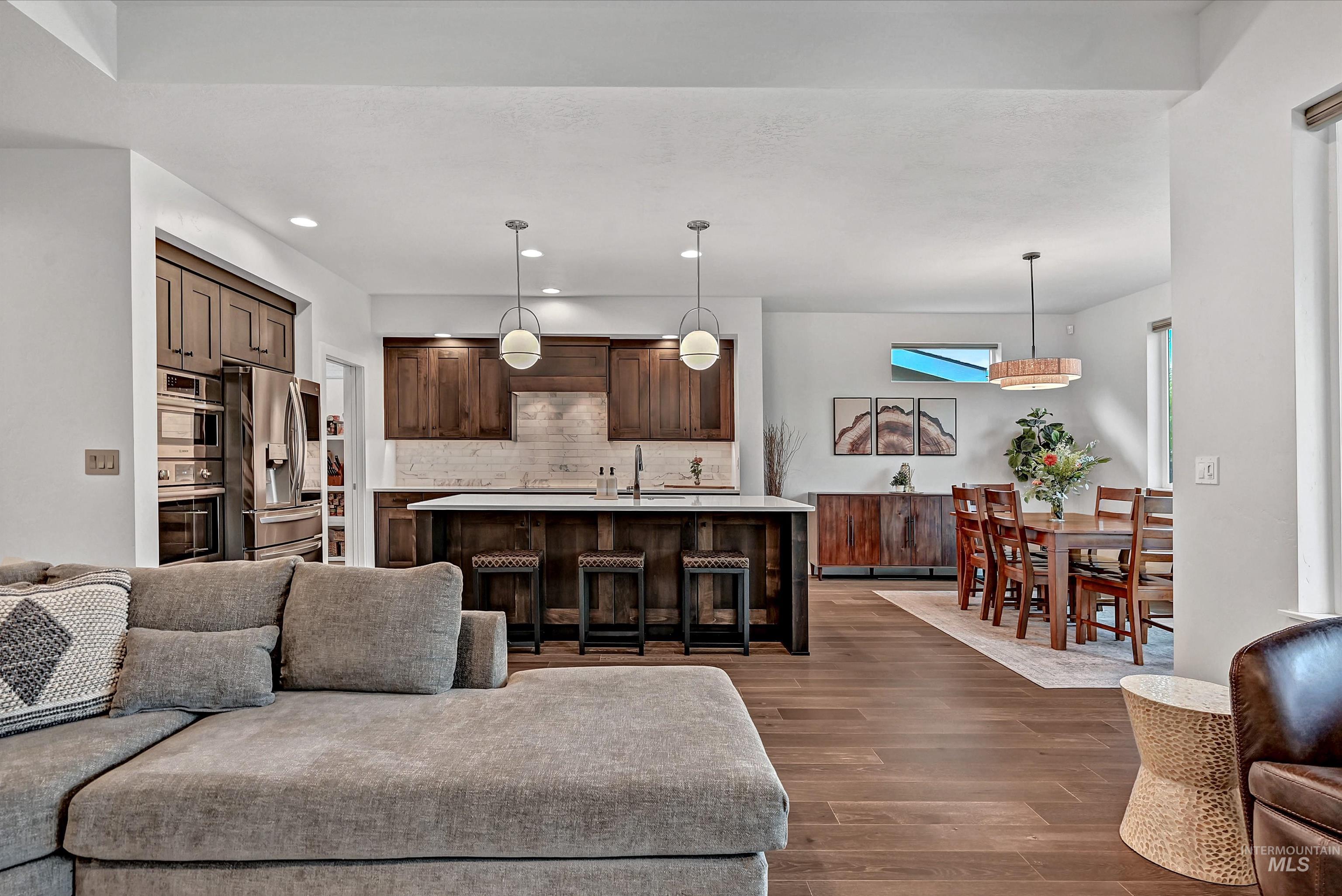 Living room featuring dark wood-style floors and recessed lighting