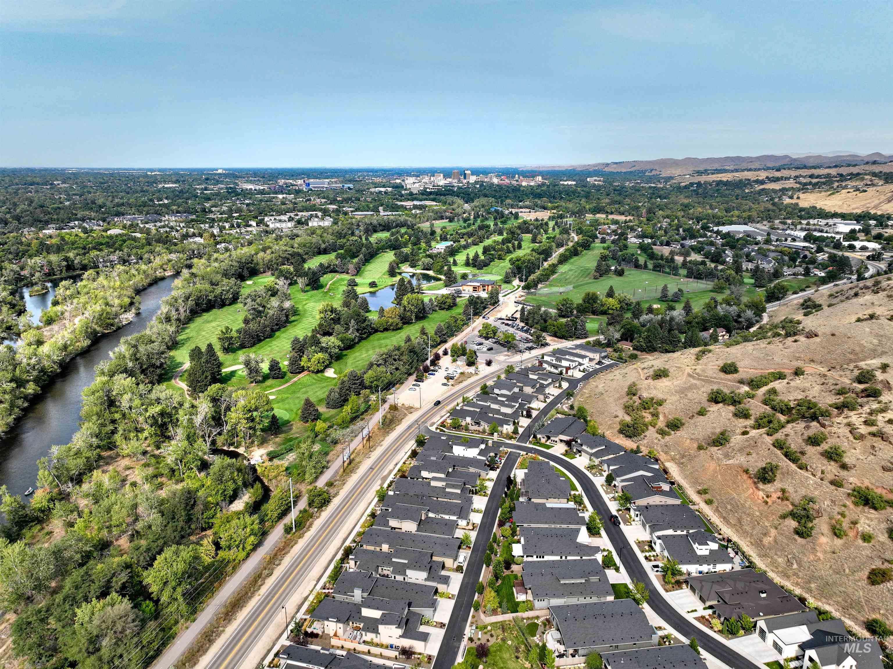 View of property location featuring a large body of water and nearby suburban area