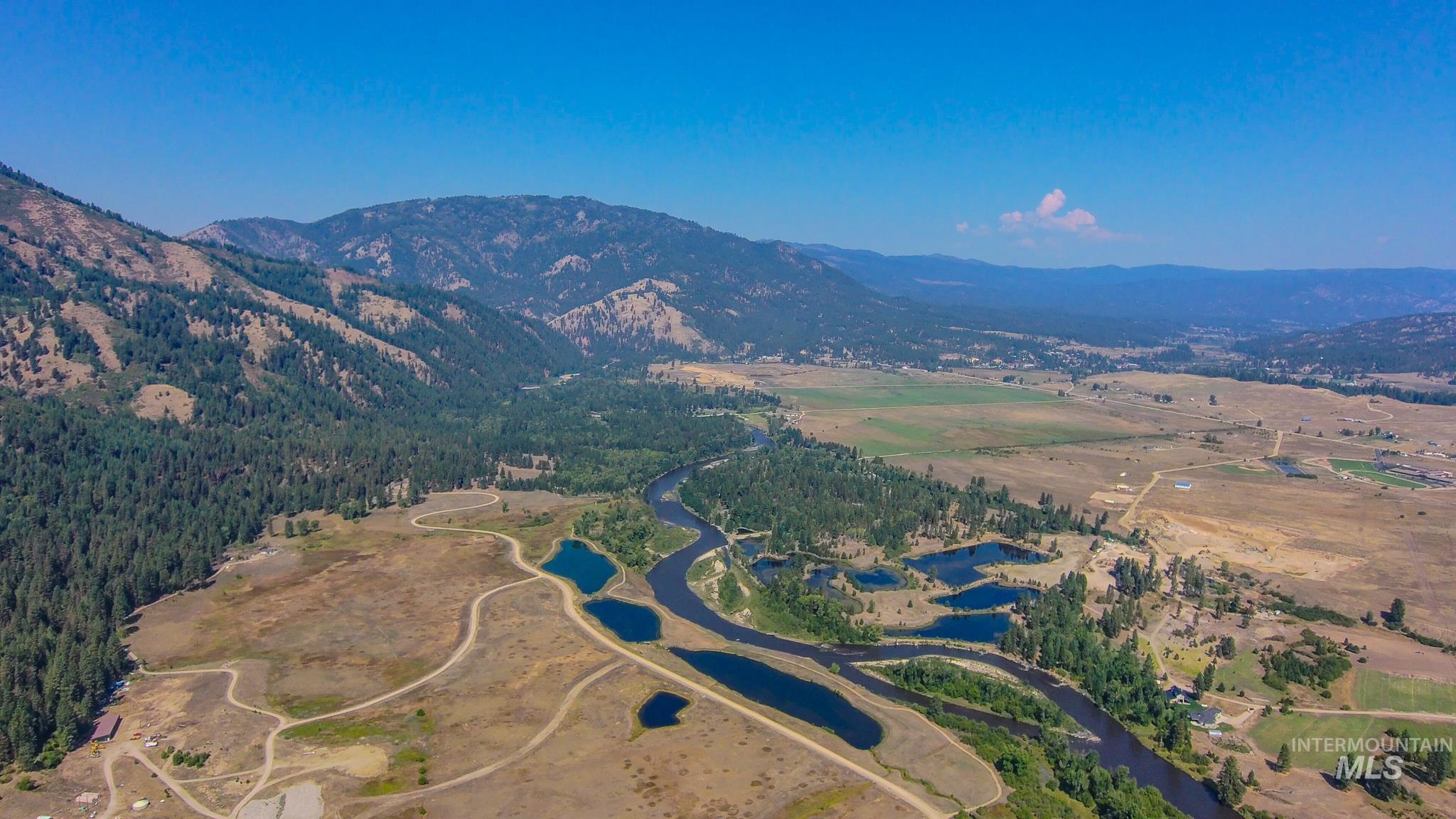 Aerial view of property's location with a water and mountain view