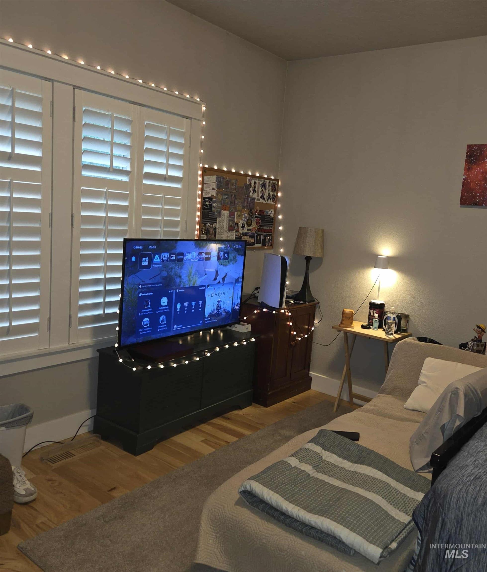 Living area with wood finished floors and baseboards