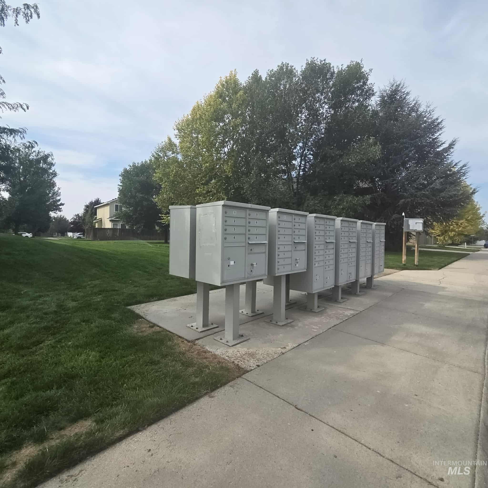 Surrounding community with mail area and a lawn