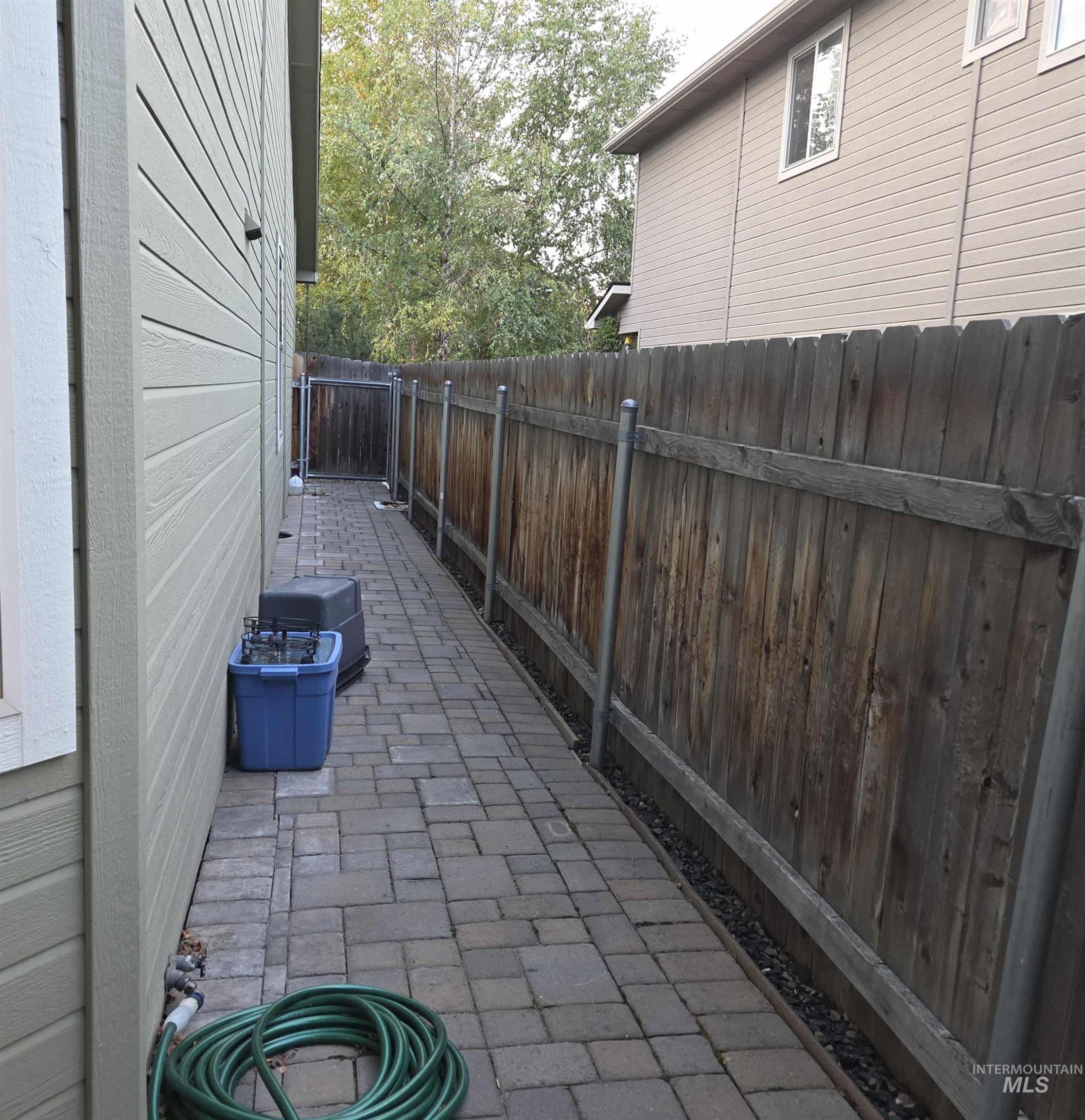 Fenced backyard with a patio