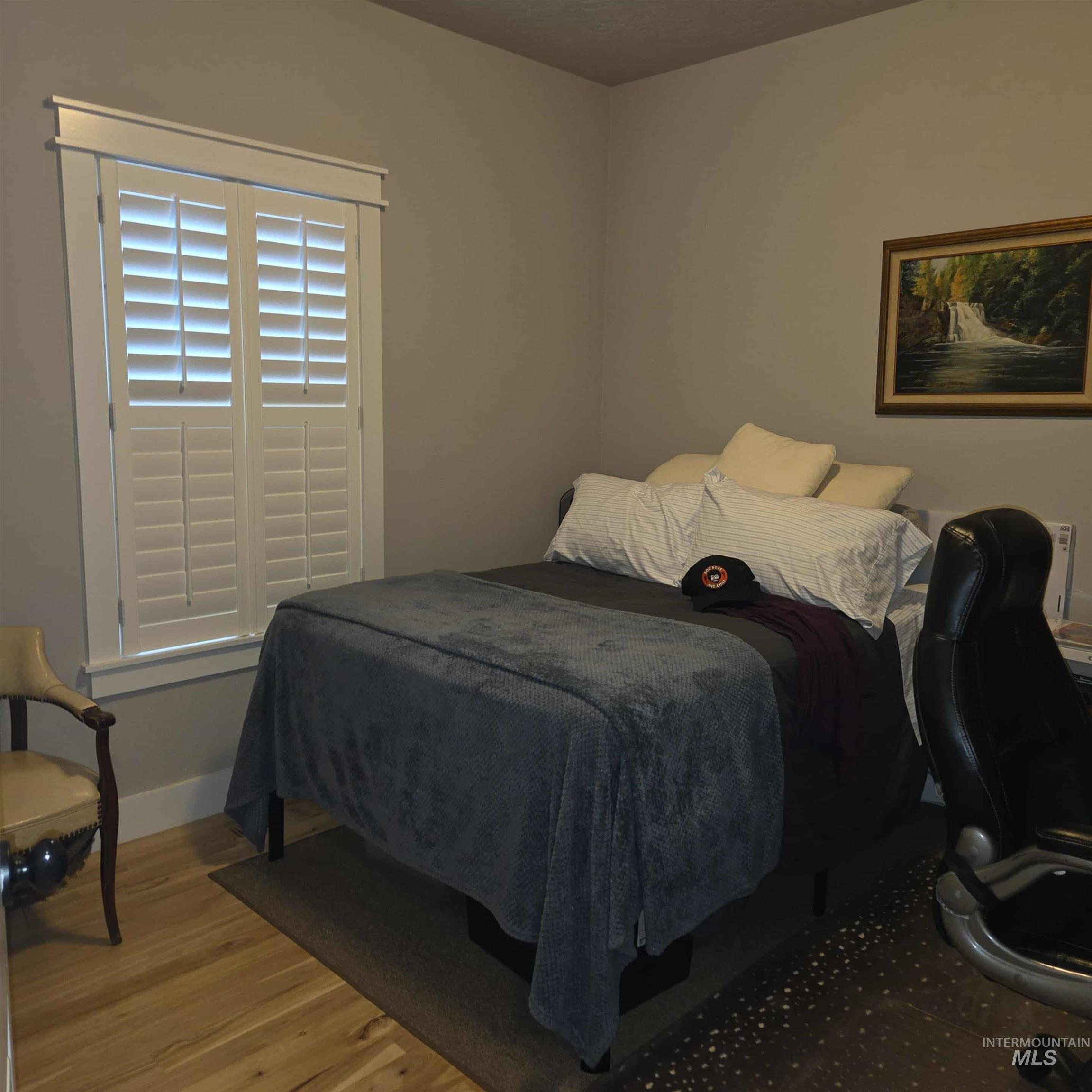 Bedroom featuring real hickory wood flooring