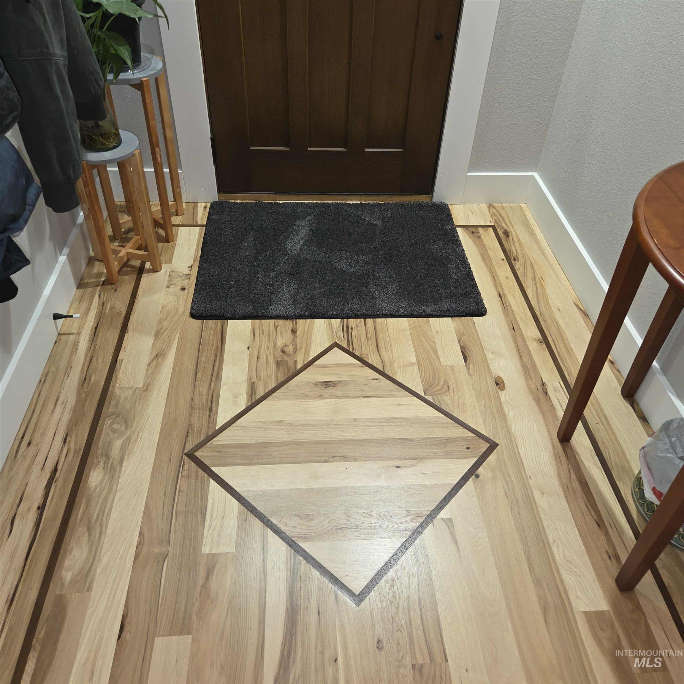 Detailed view of wood finished floors and baseboards