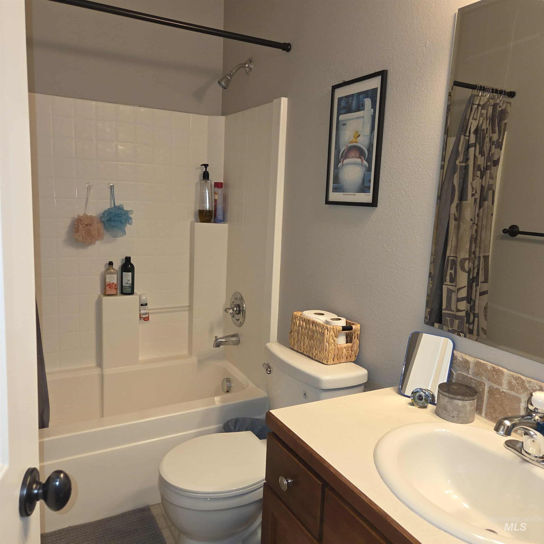 Full bathroom featuring shower / bath combination with newer toilet