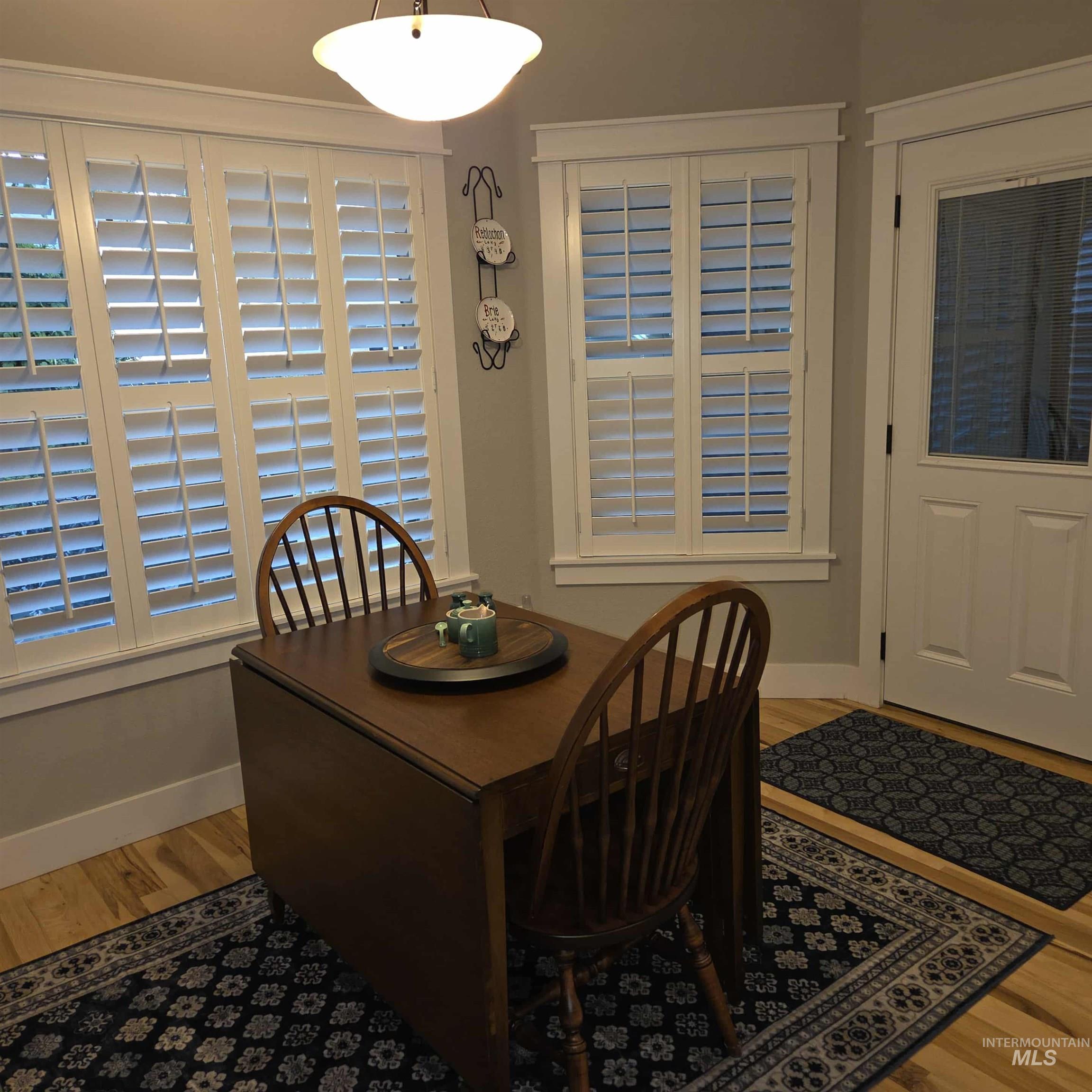 Dining space featuring light wood-style flooring and baseboards