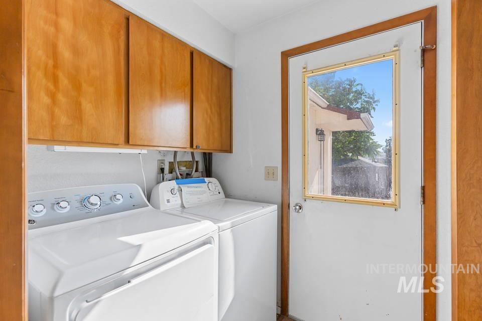Laundry room featuring cabinet space and independent washer and dryer