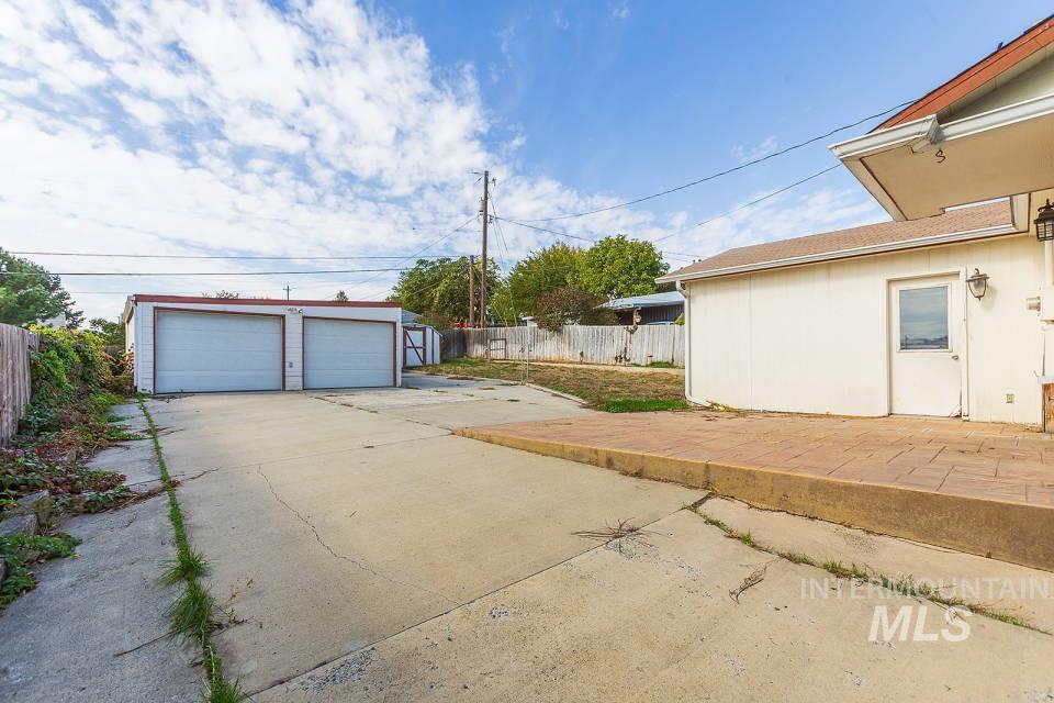 View of yard featuring an outbuilding, a garage, and a patio