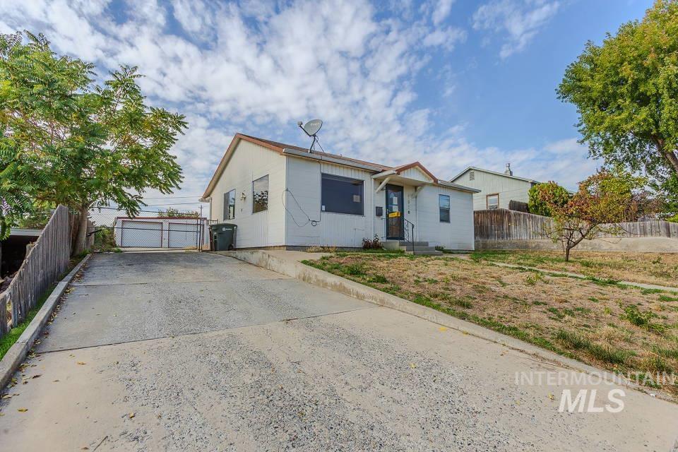 Bungalow-style home with a gate and a garage
