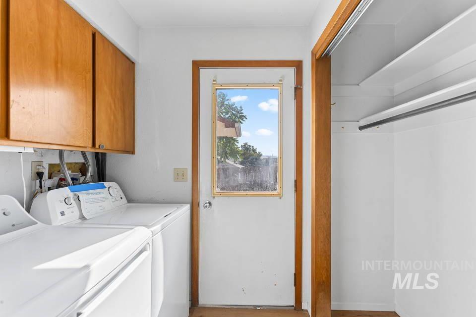 Laundry area with washer and clothes dryer and cabinet space