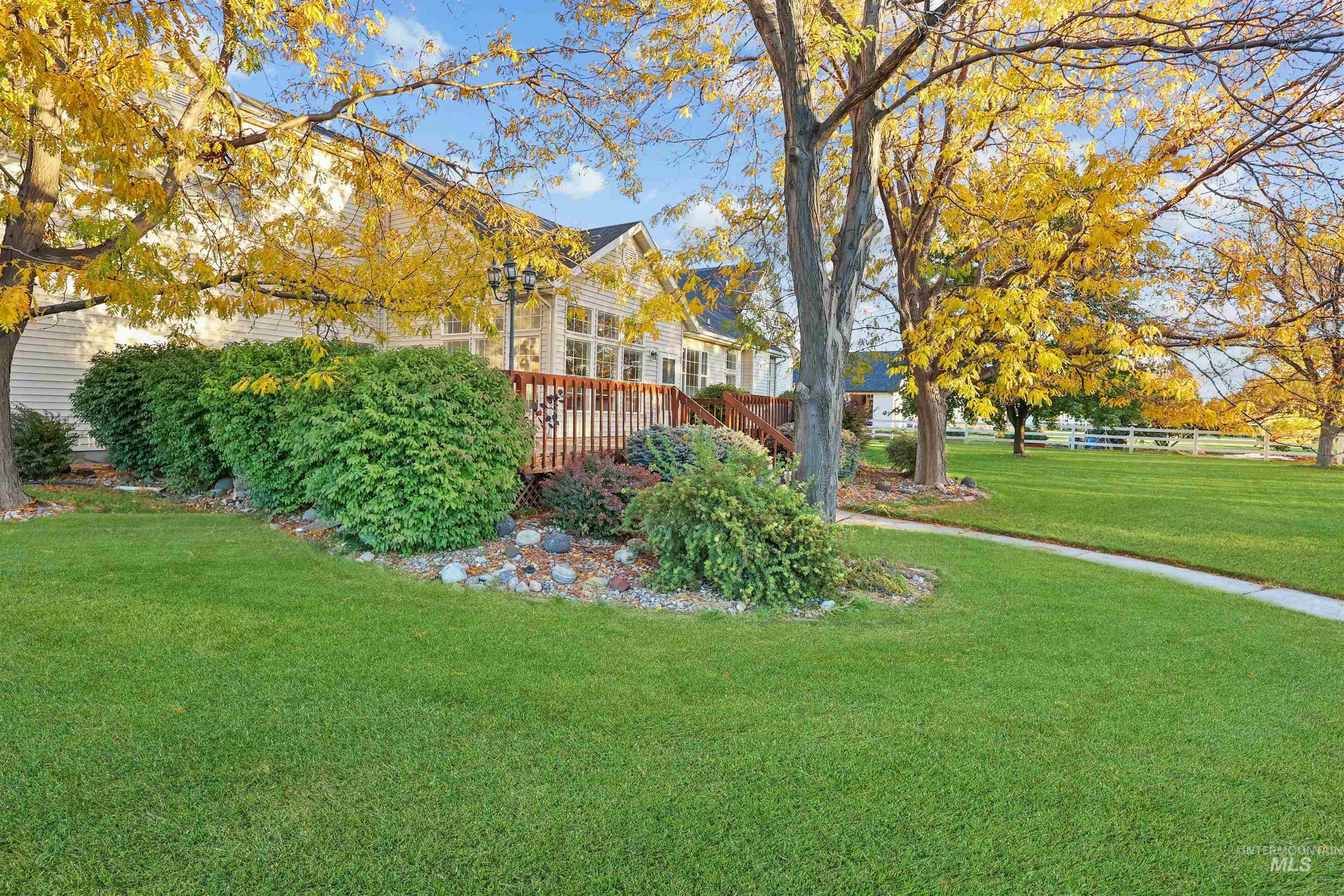 View of green lawn with a deck