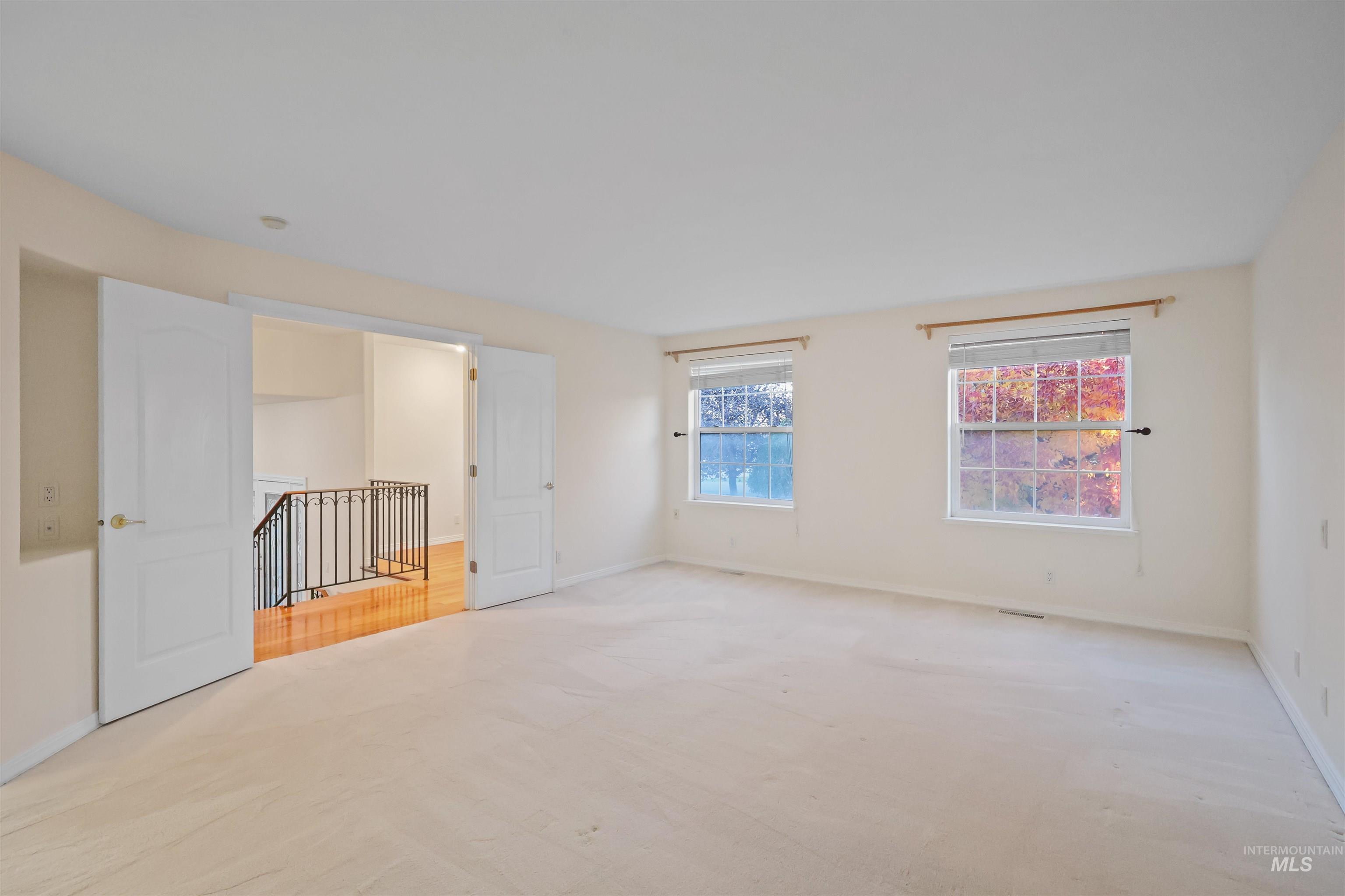 Spare room with baseboards and carpet