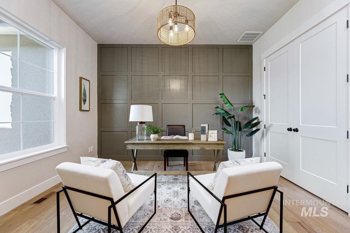 Office area featuring a decorative wall and light wood-style floors