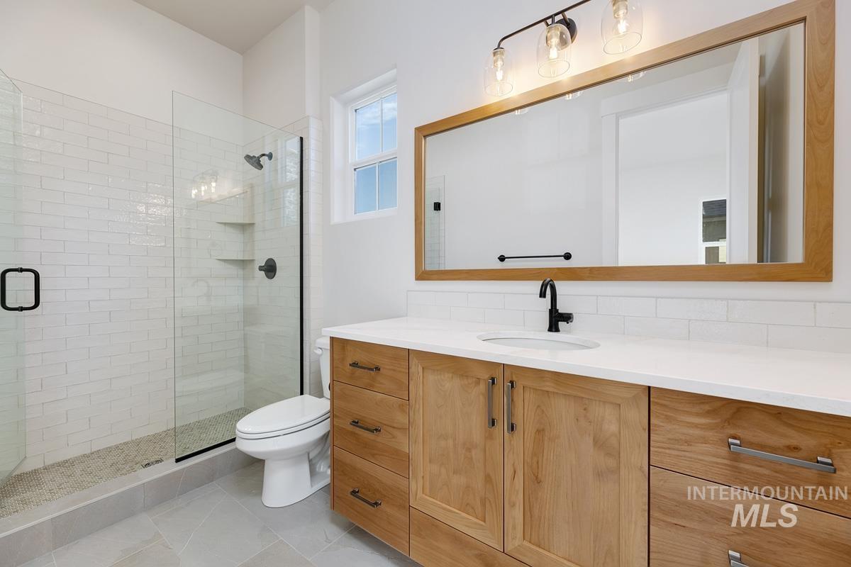 Full bathroom featuring vanity and a stall shower