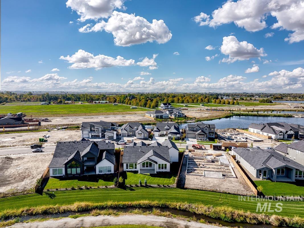 Aerial perspective of suburban area featuring a large body of water