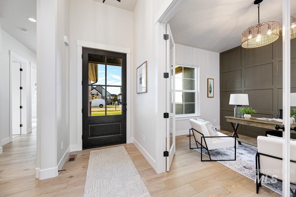 Entrance foyer featuring light wood-style floors and a chandelier
