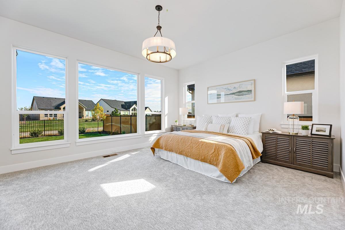 Bedroom featuring carpet and baseboards