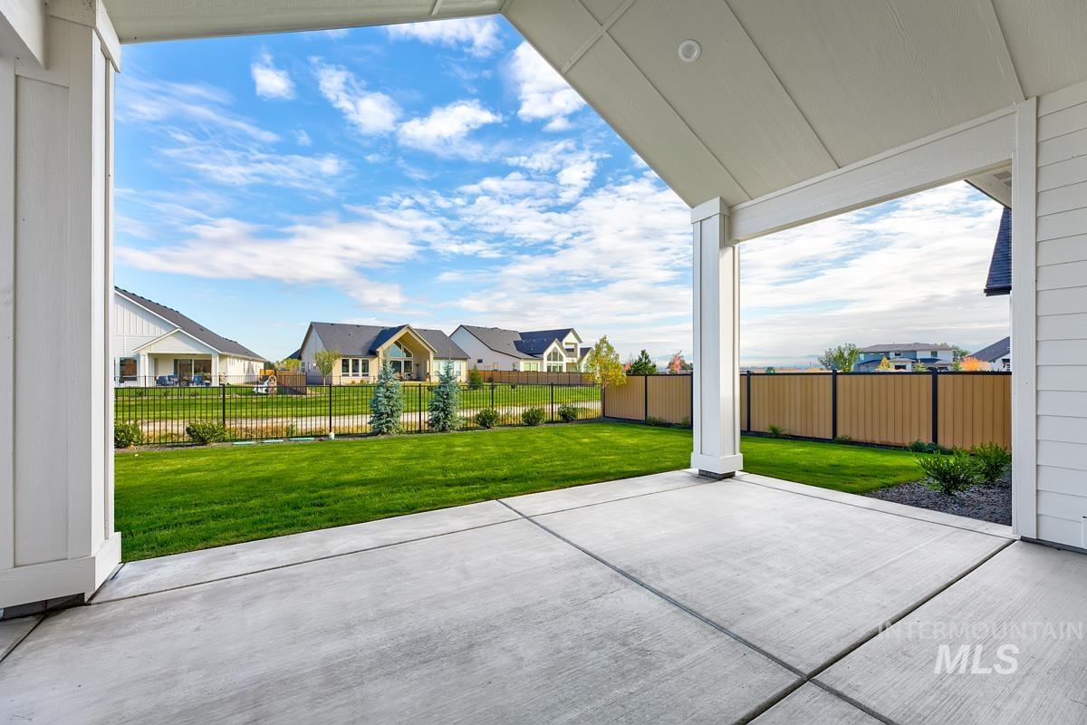 Fenced backyard featuring a patio area and a residential view