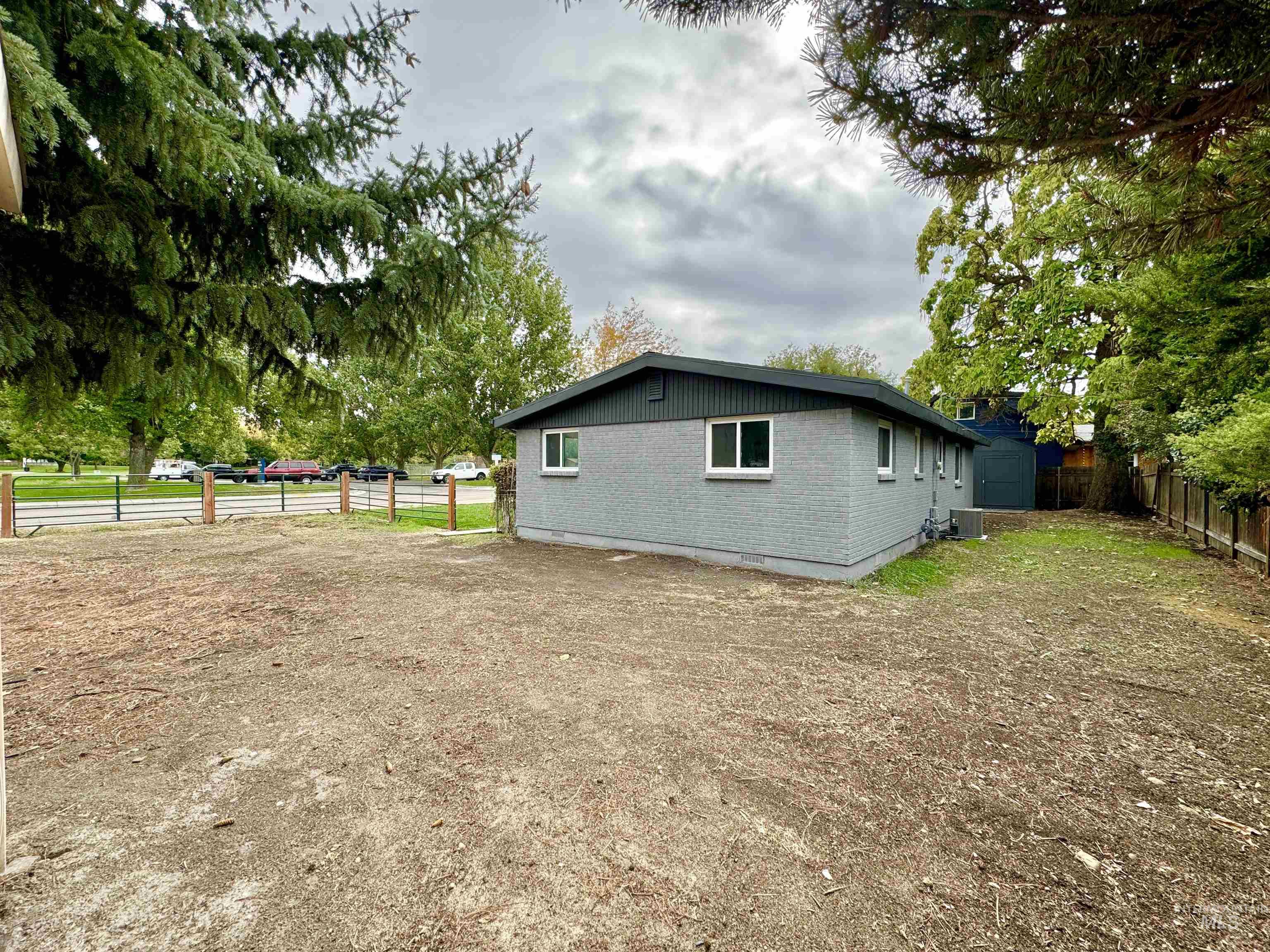 View of side of property with a fenced backyard and brick siding