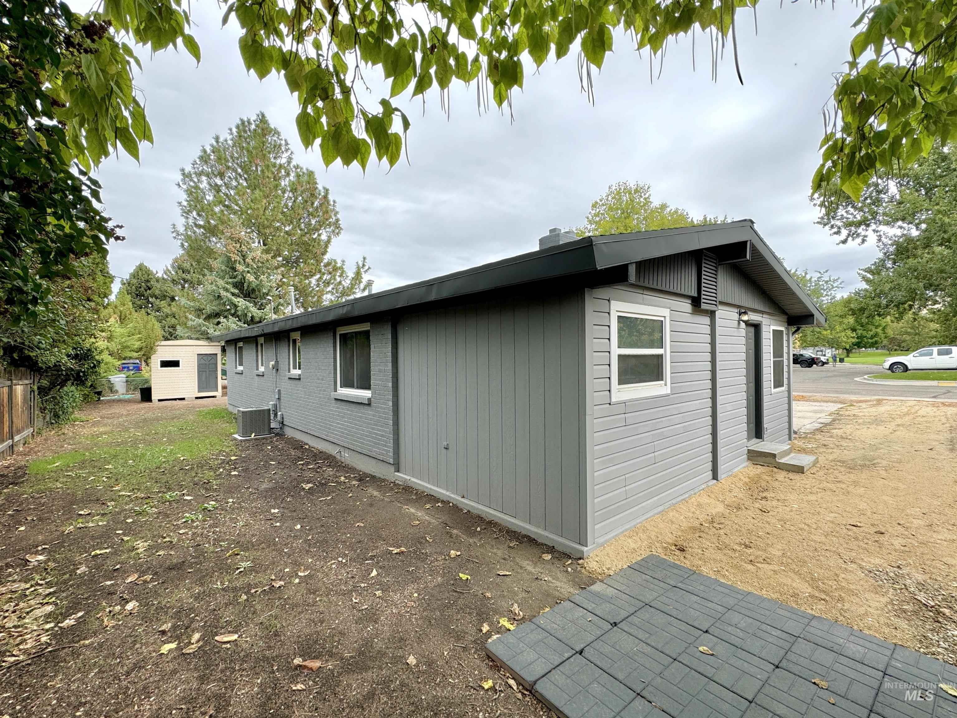 View of side of property with a cooling unit