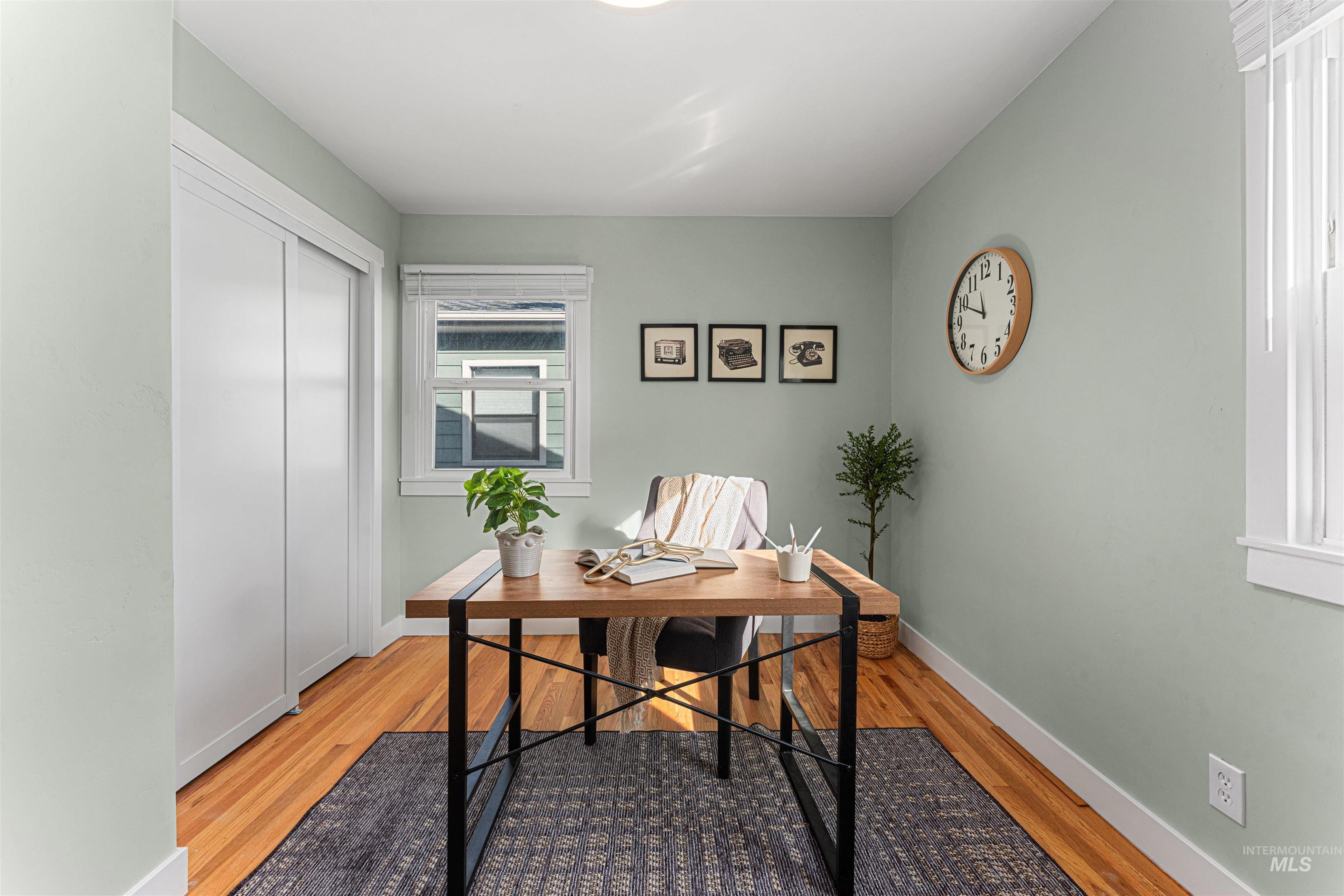 Bedroom with light wood finished floors and baseboards