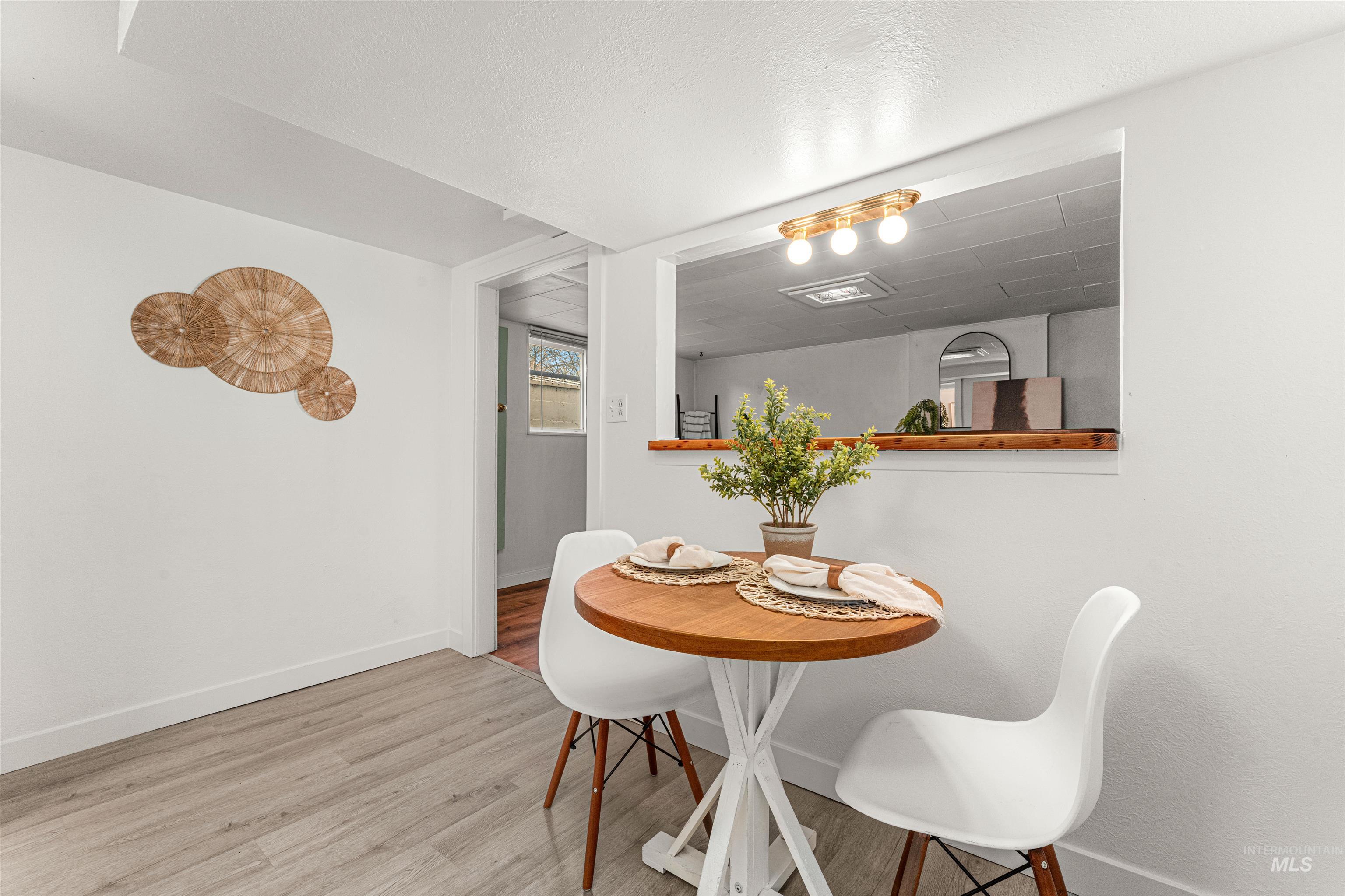 Kitchen featuring electric range, white cabinets, and light wood-style floors