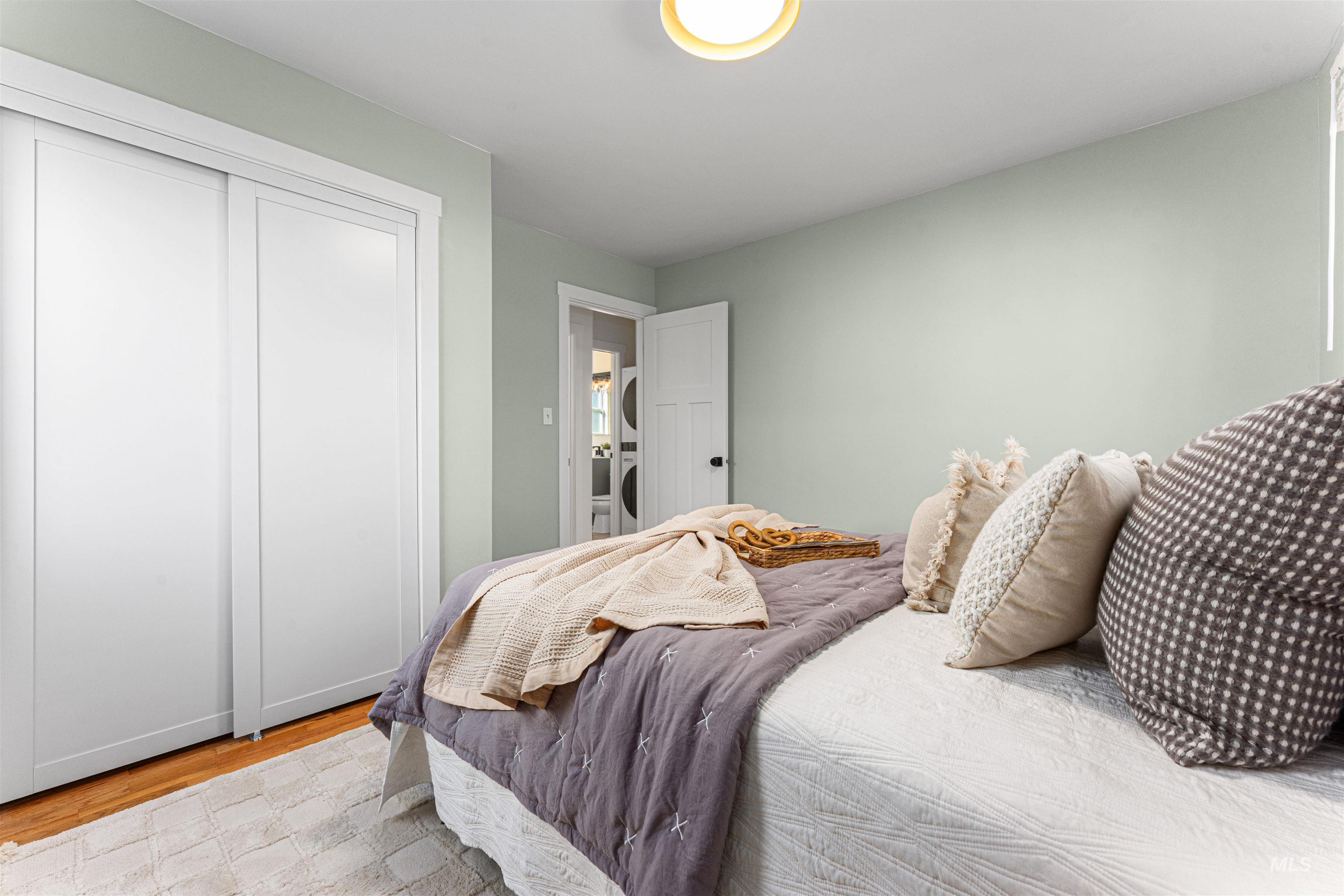 Kitchen with stainless steel appliances, glass insert cabinets, light countertops, and light marble finish flooring