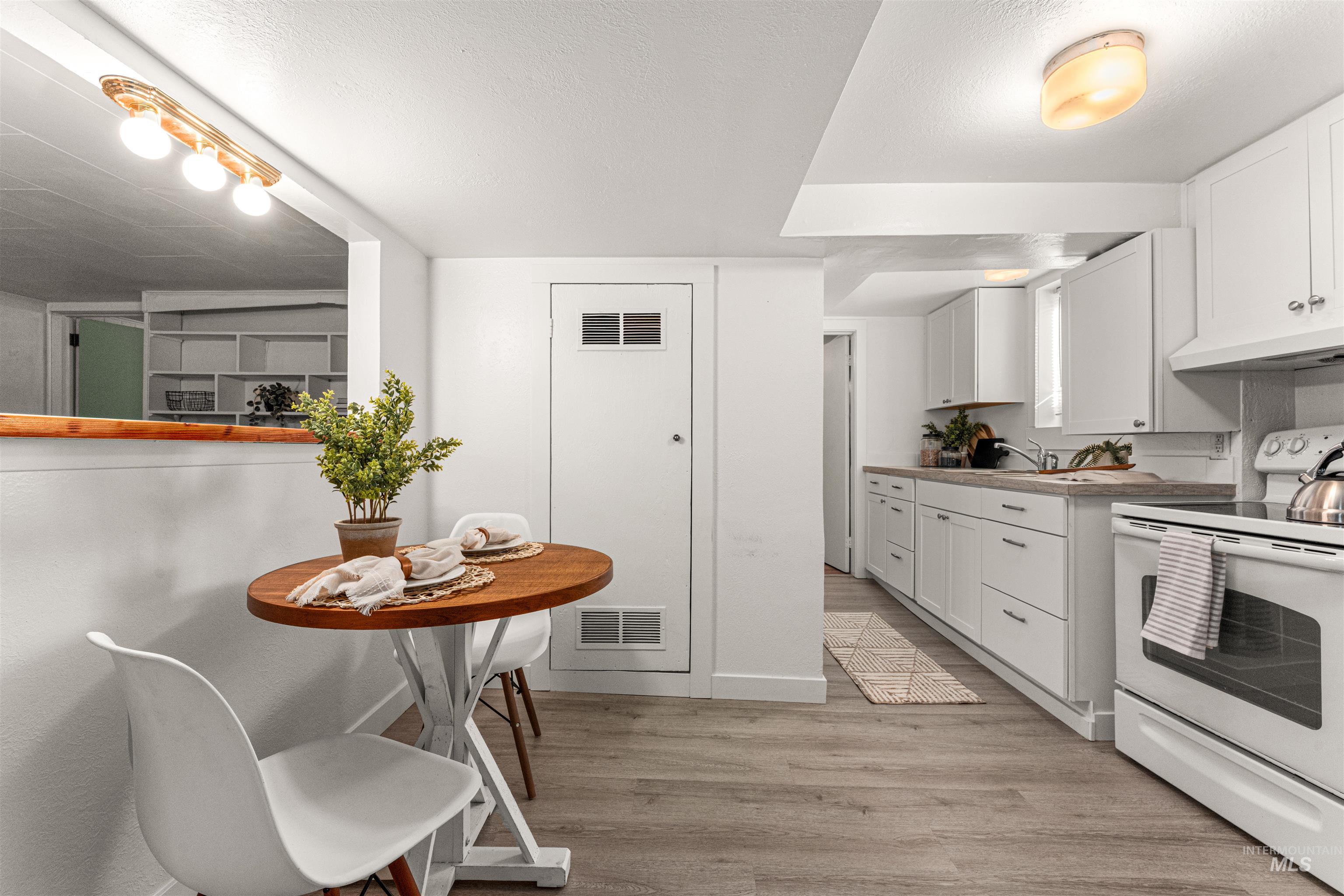 Living area with wood finished floors and baseboards
